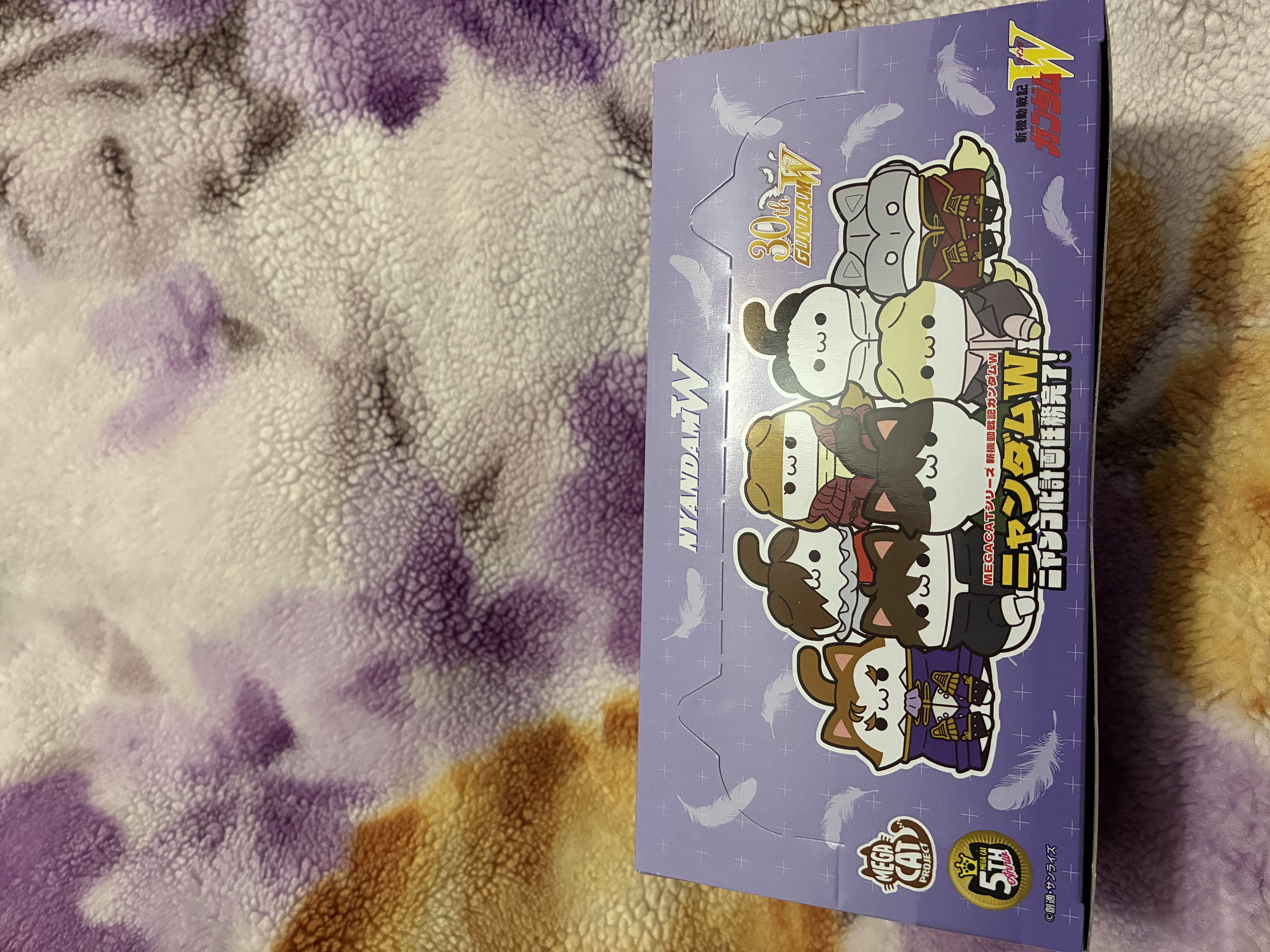 Box of Gundam wing cat figure with a cat shaped opening.