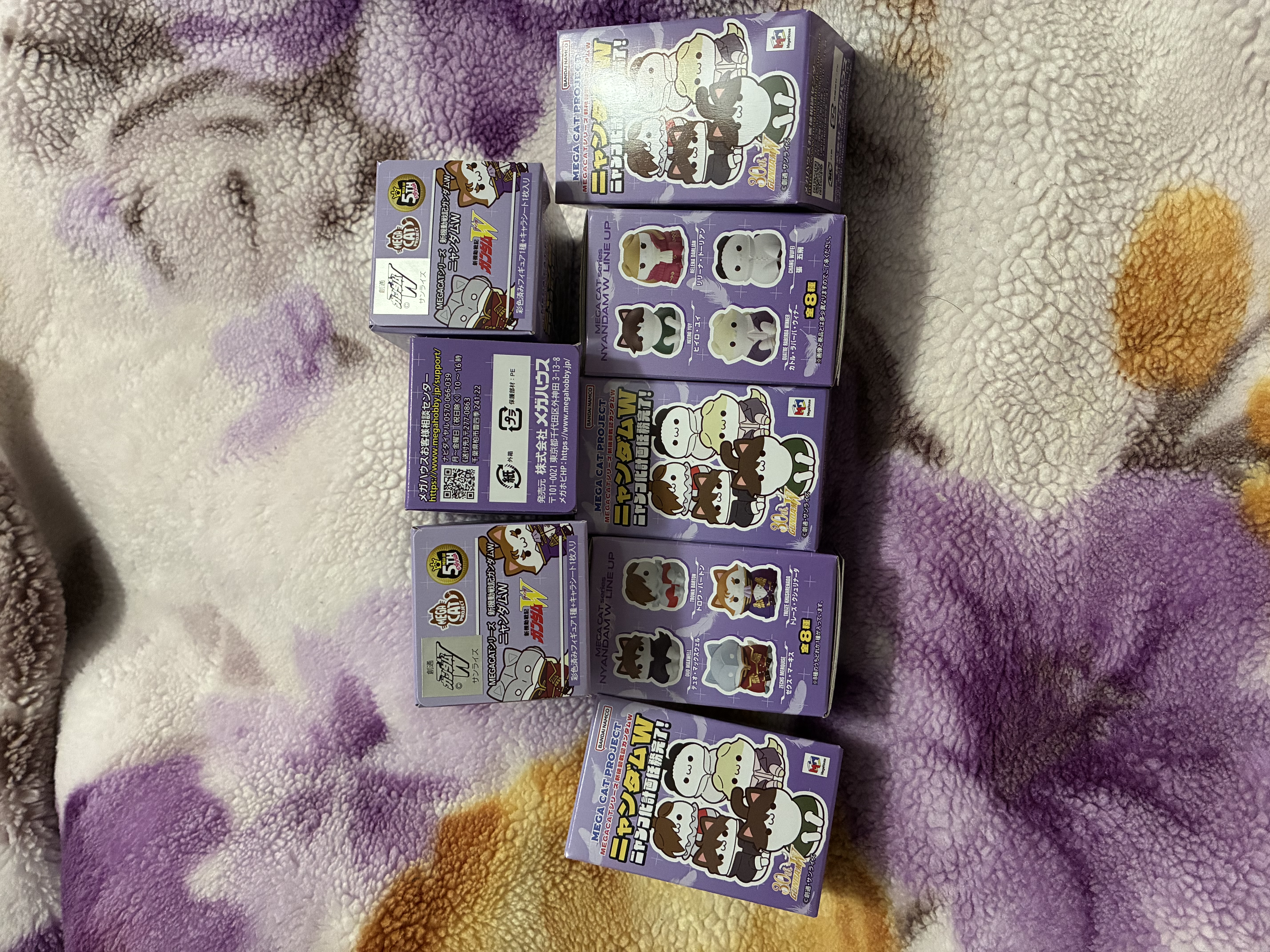 Eight small boxes of each Gundam wing cat figure.