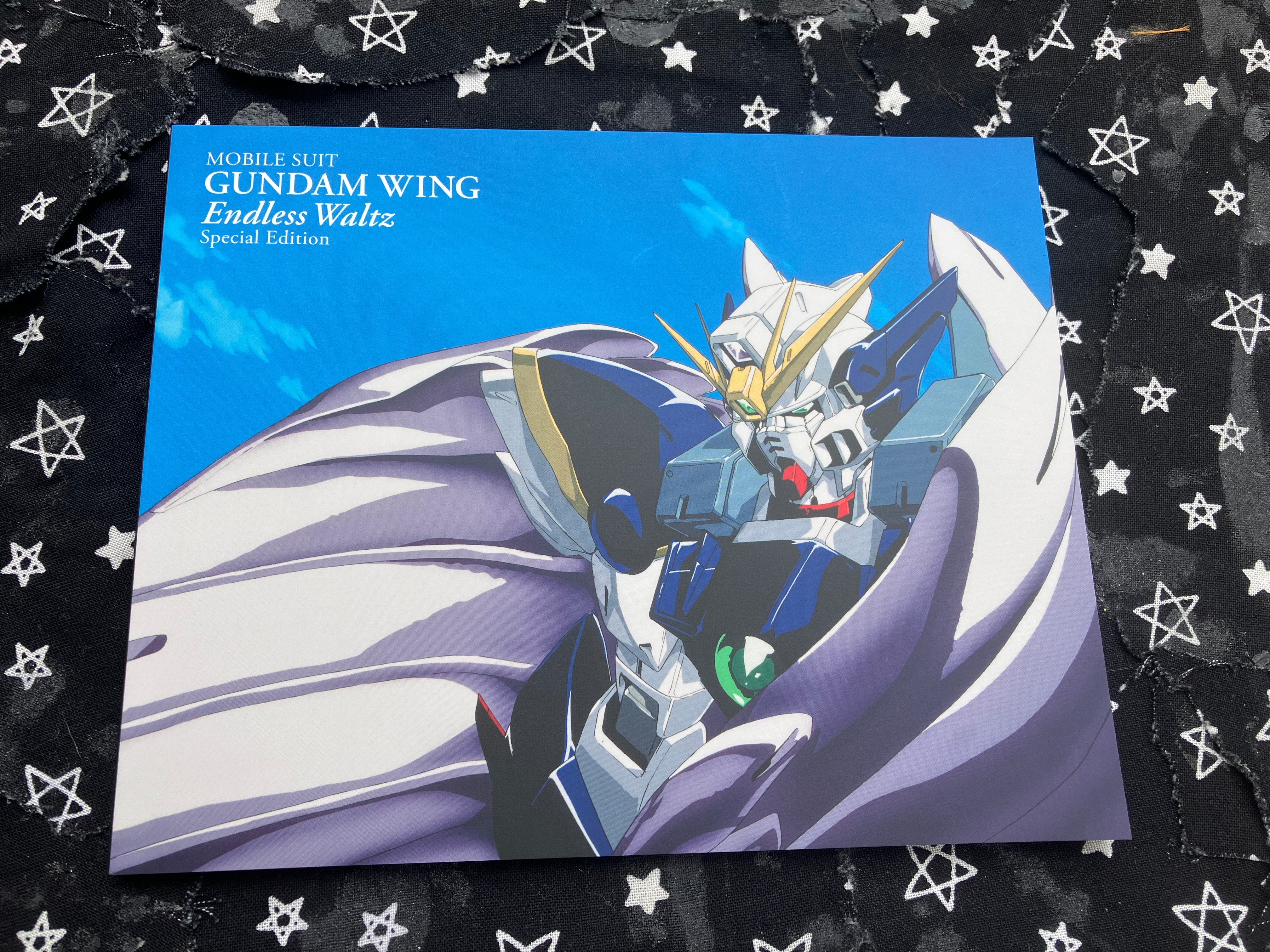 Front of Gundam wing endless waltz special edition booklet with Wing zero with its wings curled in on the cover.