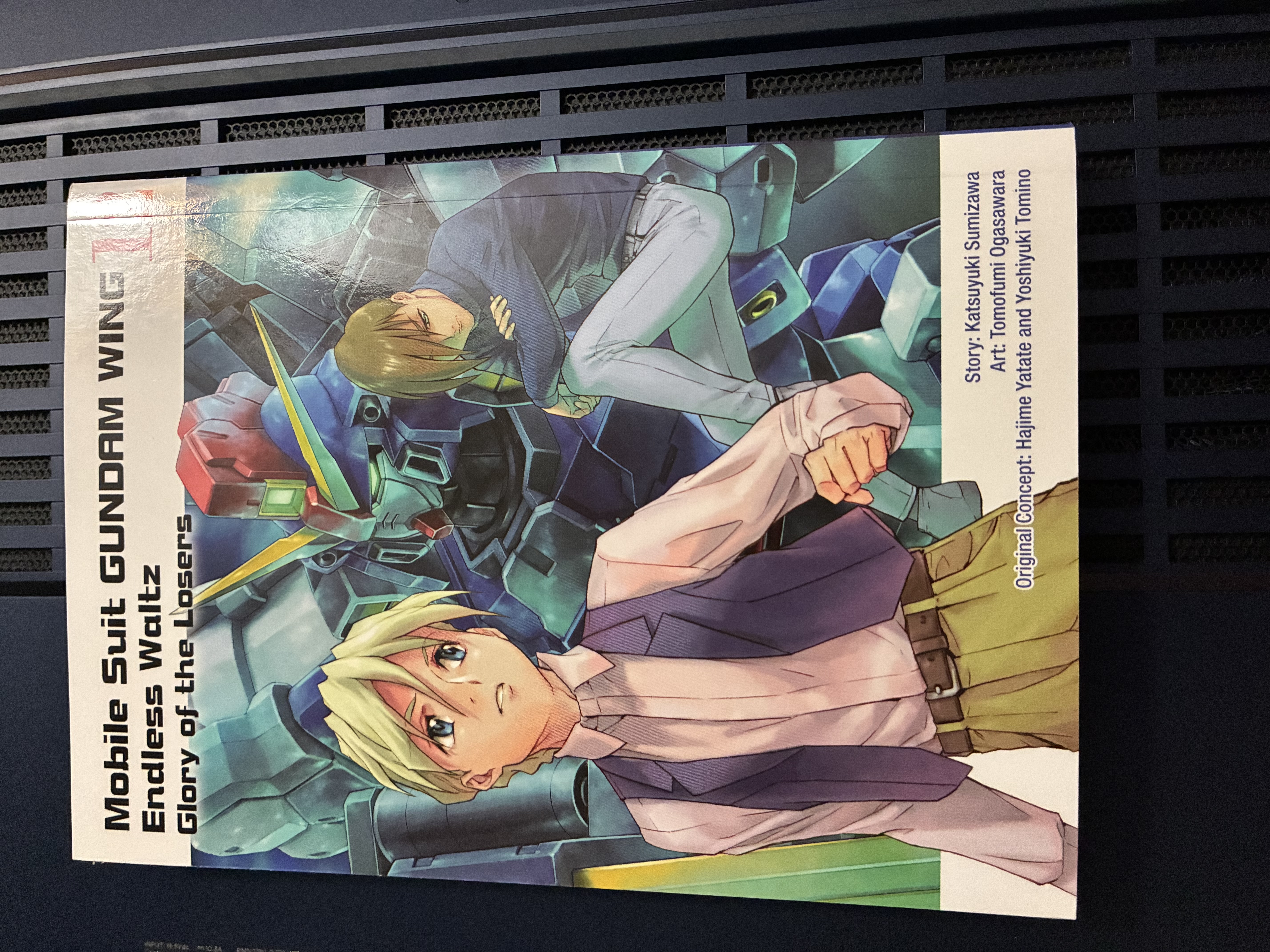 Front of Gundam Wing Endless Waltz: Glory of the Losers Volume 12 showing Quarte and Trowa and Sandrock in the background