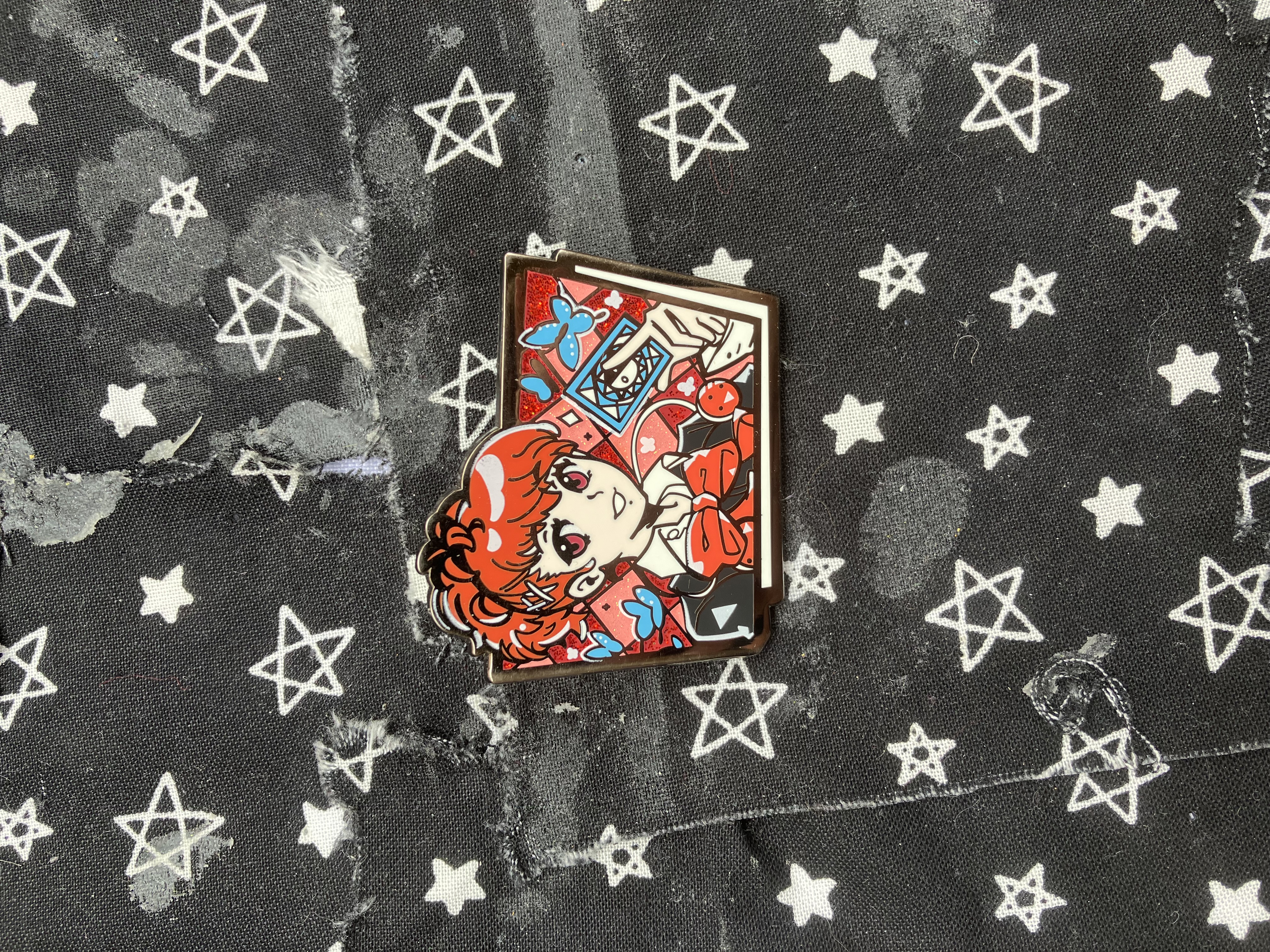 Enamel pin of Persona 3 Kotone holding a wild card with butterflies surrounding her.