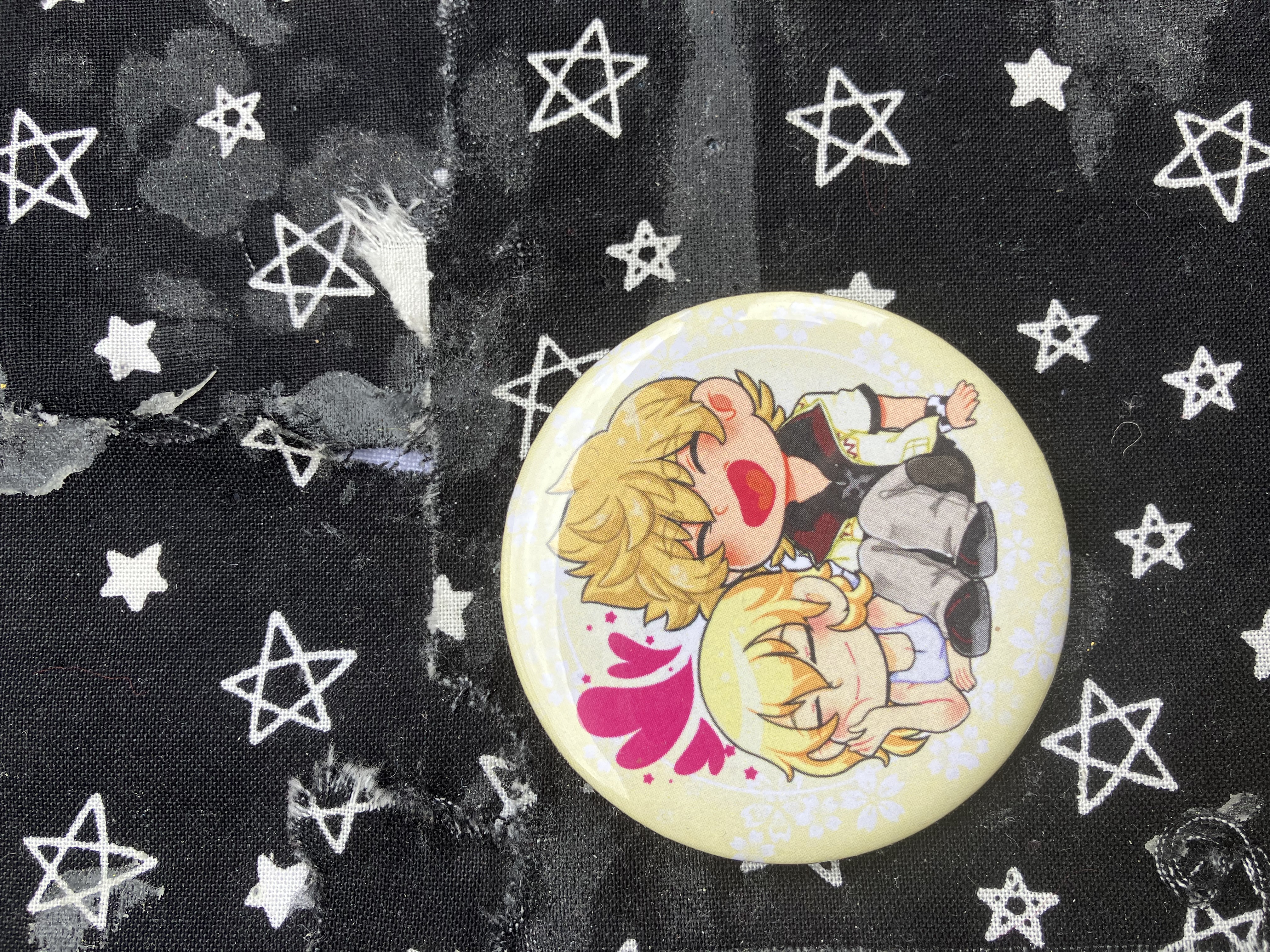 Button of Kingdom hearts Roxas and Namine. Roxas is sitting and Namine is laying down with hearts on top of them.