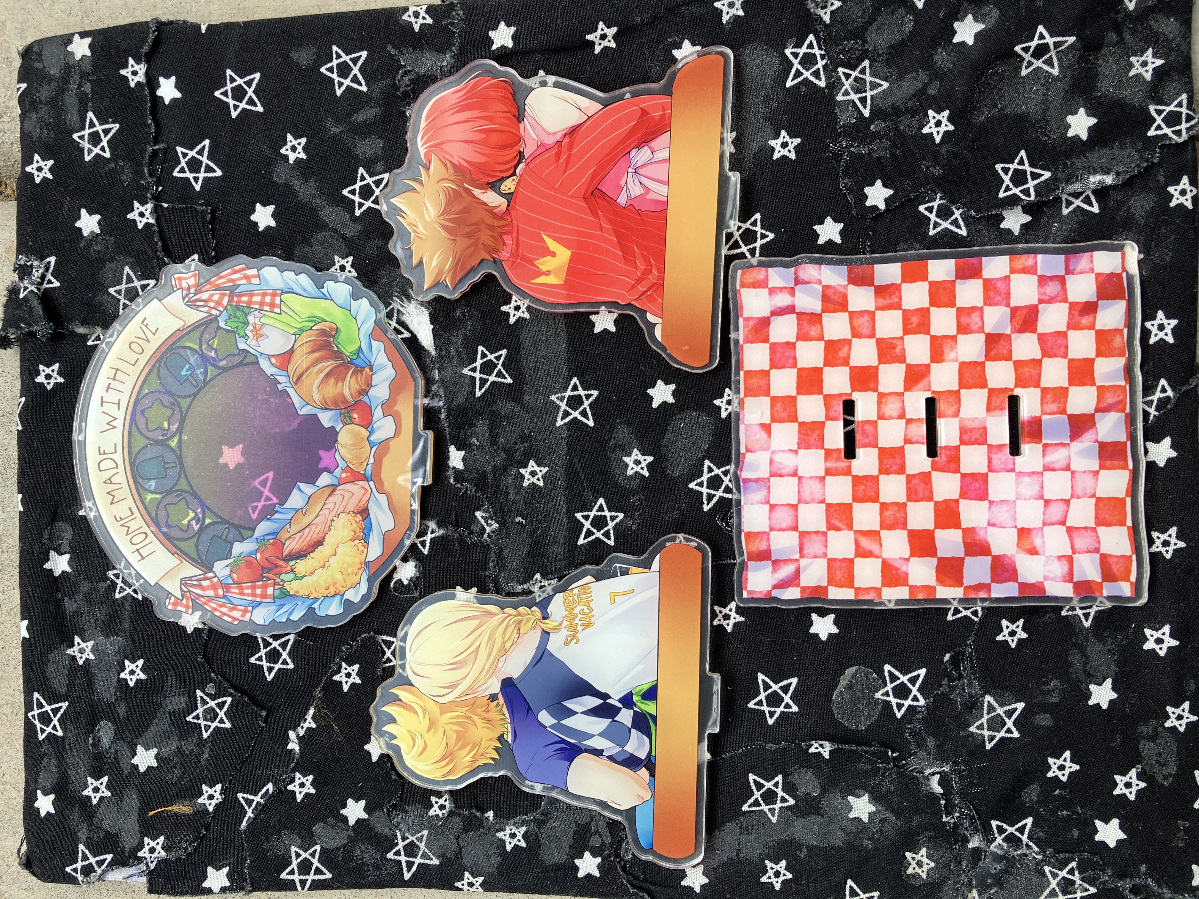 Back of acrylic standee of Kingdom hearts Kairi, Roxas, Namine, and Sora in casual clothes with food surrounding them in a kitchen.