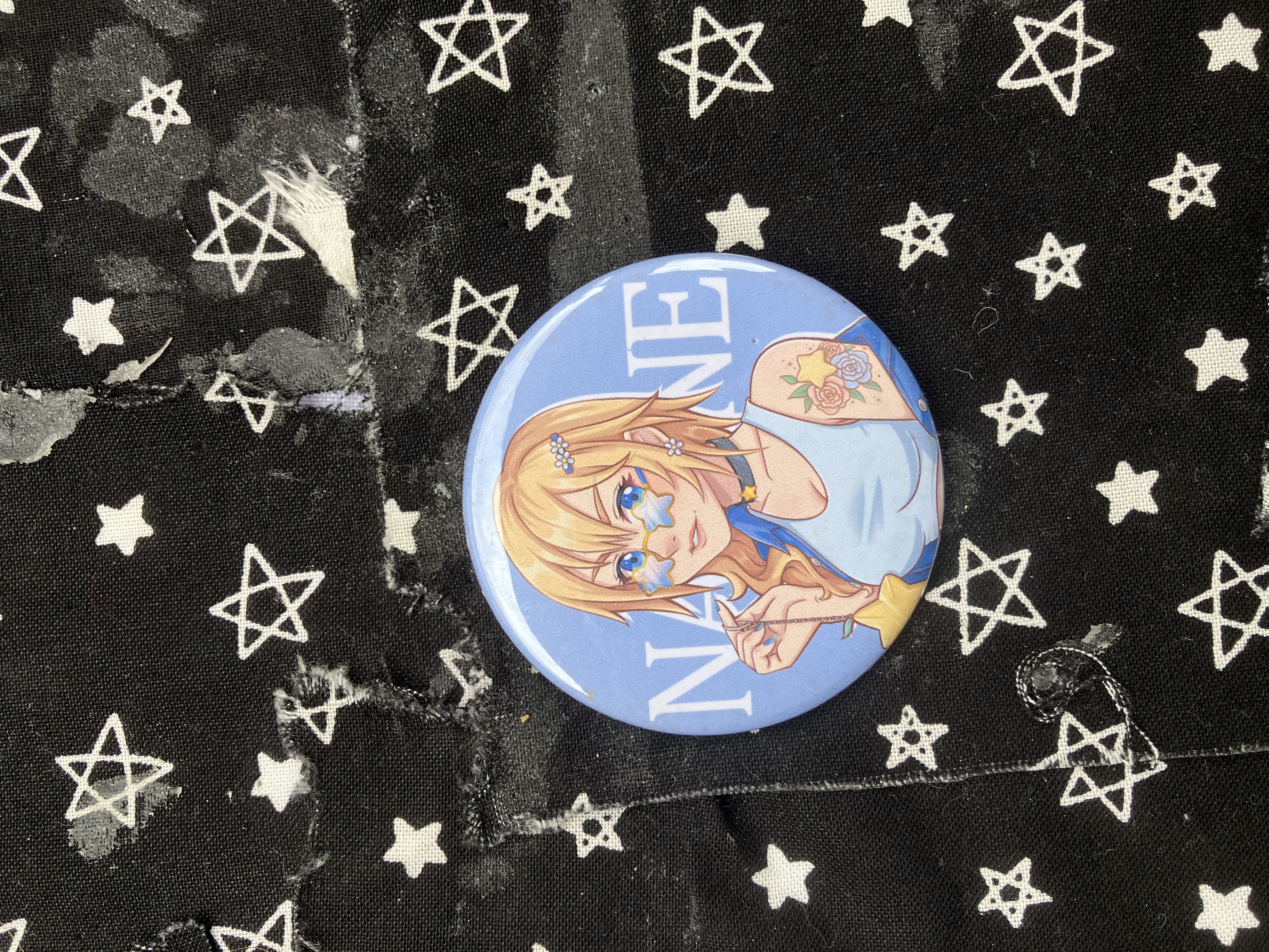 Button of Kingdom Hearts hipster styled Naminé with glasses, tattoos and holding her lucky charm.