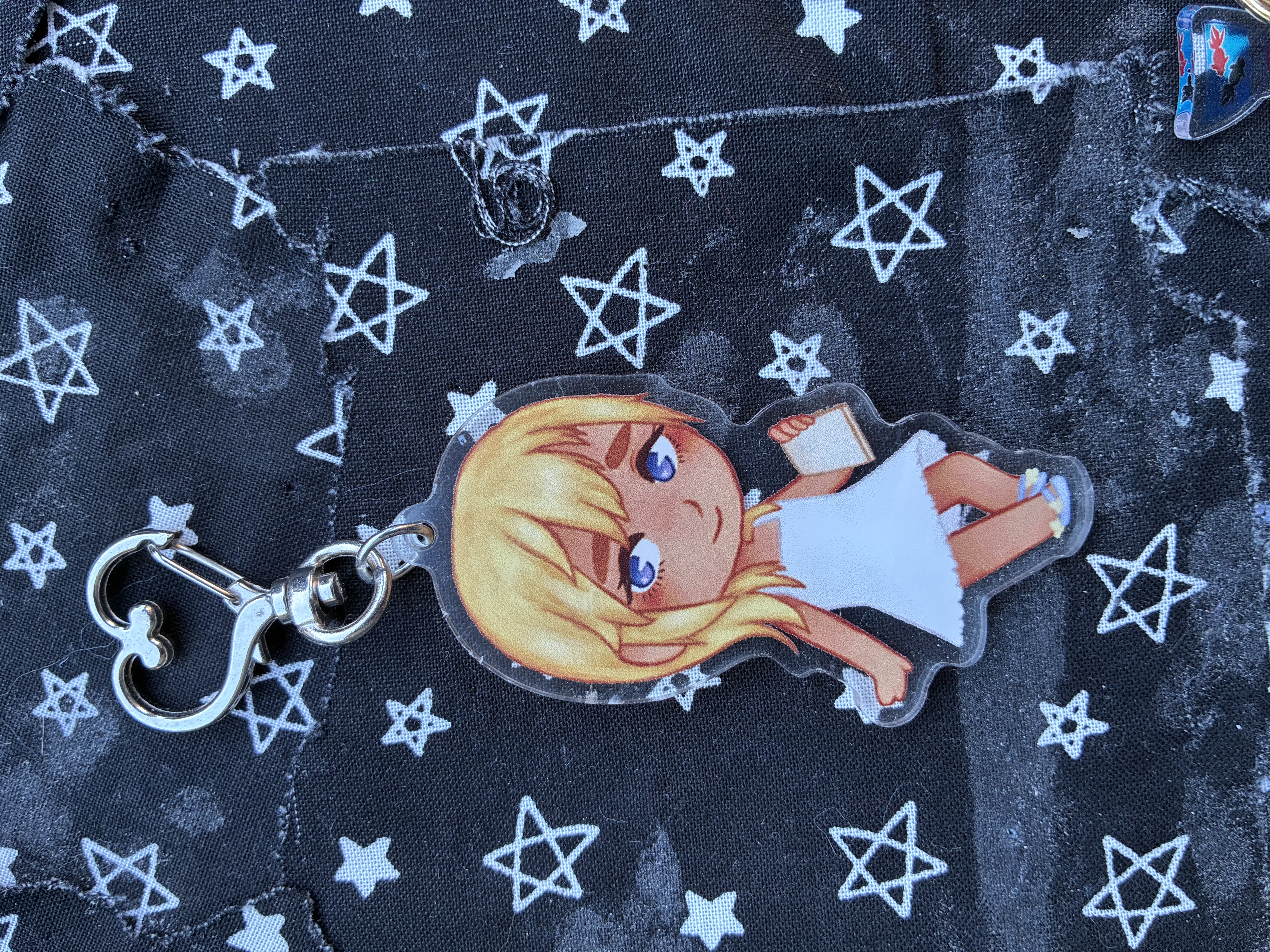 Acrylic charm of Kingdom hearts Namine holding her sketchpad.