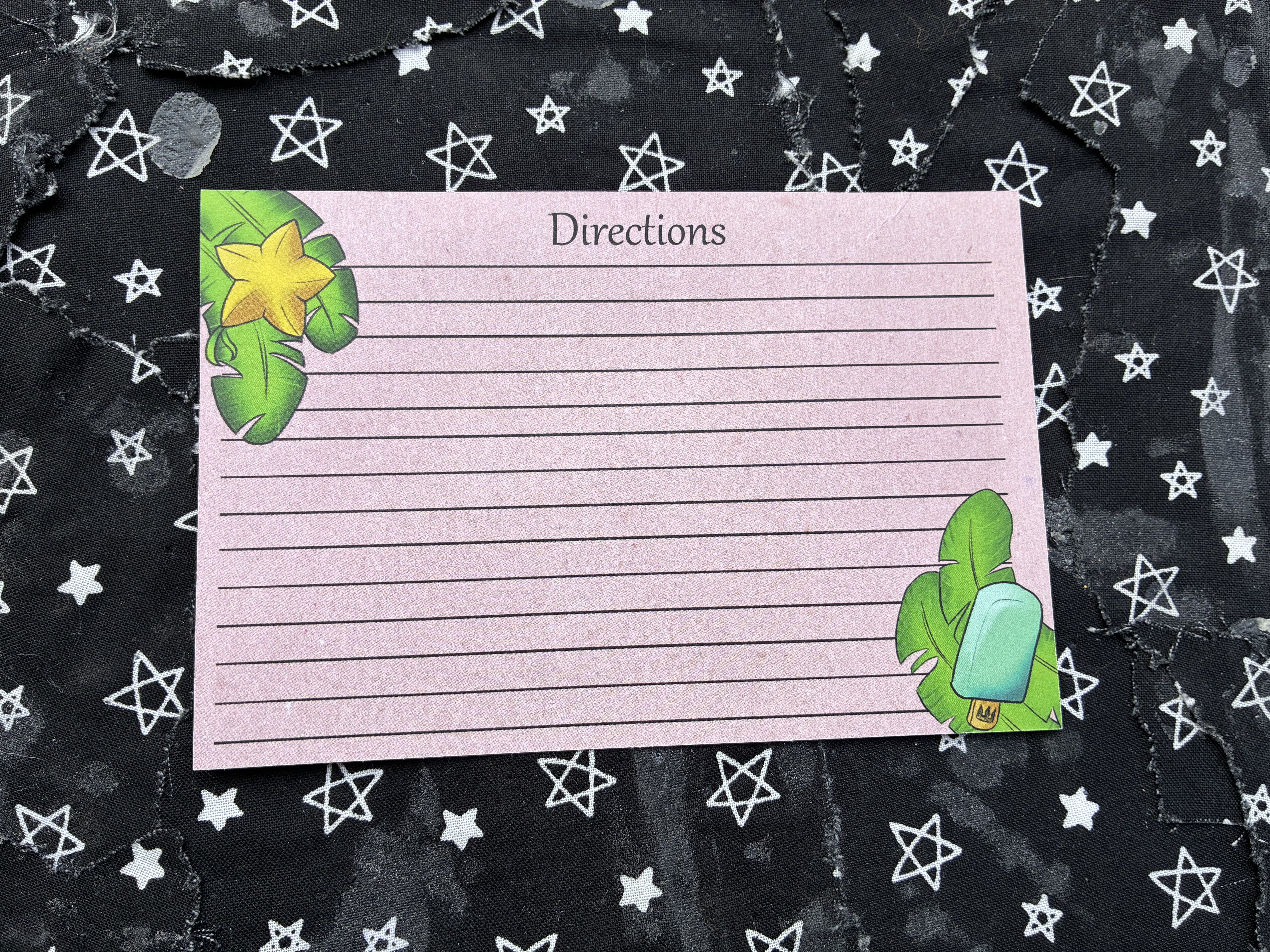 Cooking direction sheet decorated with a paopu fruit and sea salt ice cream on leaves.