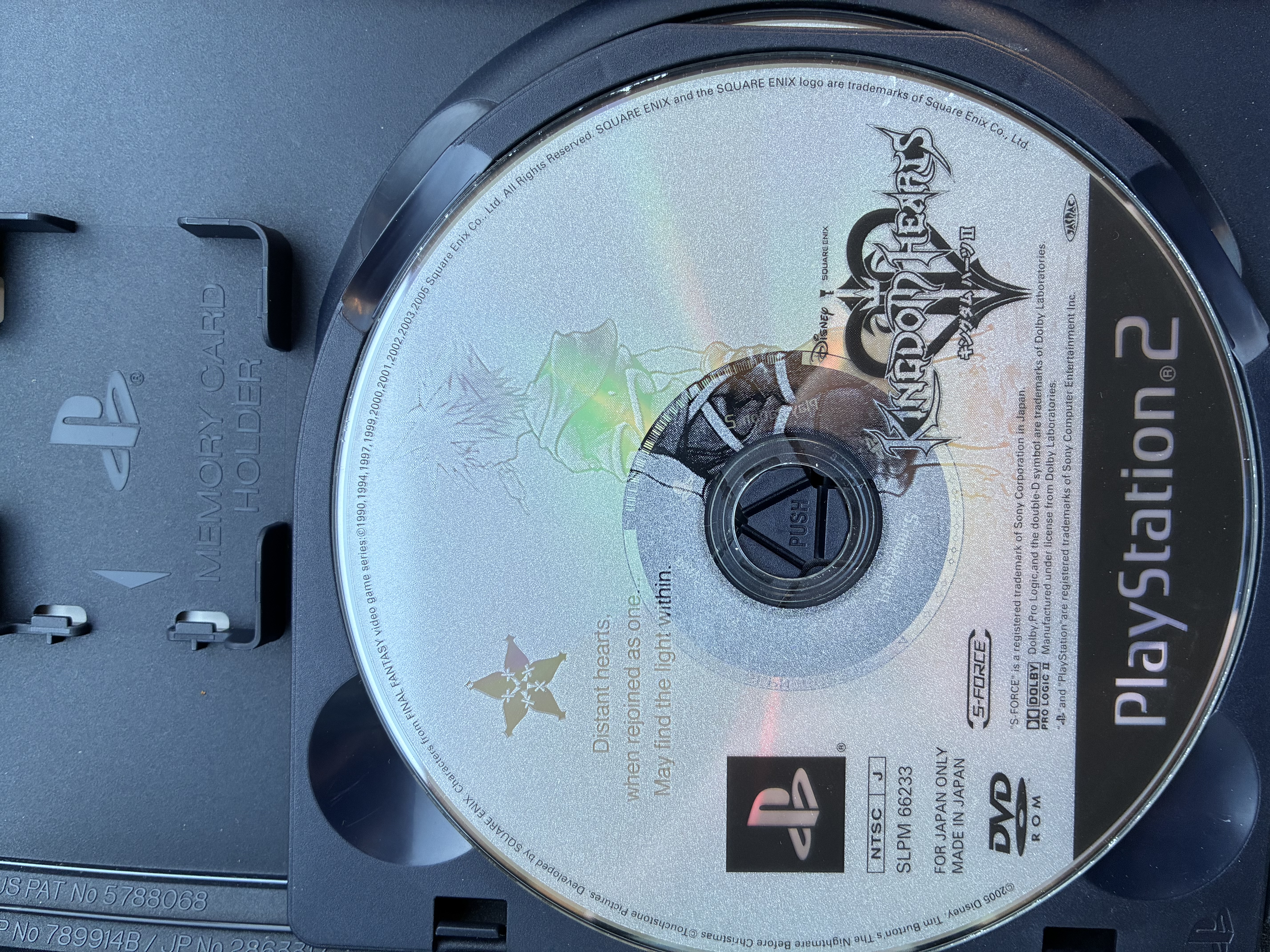 Disc of Kingdom hearts 2 final mix in a disc tray.