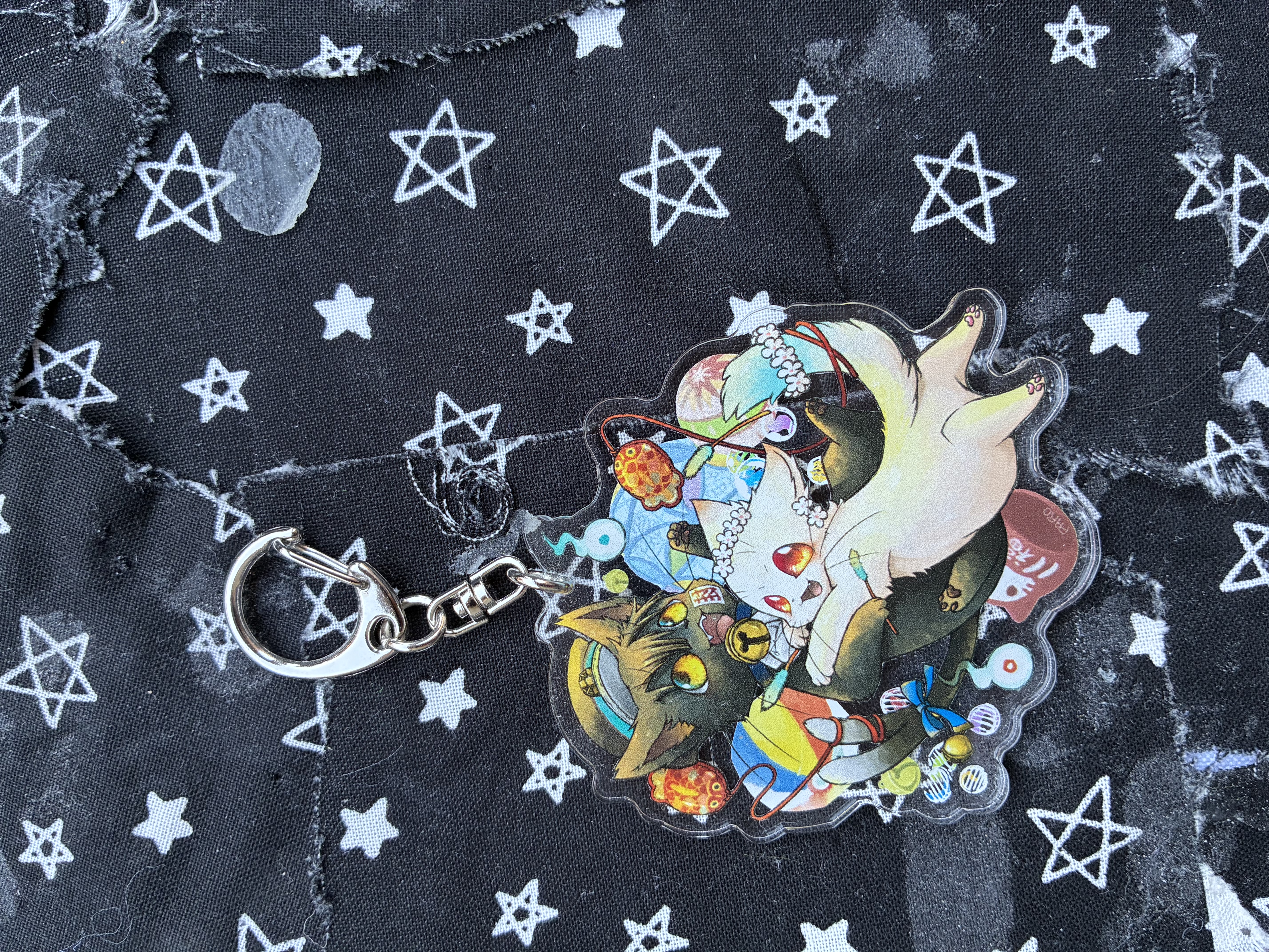 Acrylic charm of Jibaku shounen Hanako kun bakeneko ryokan hanako tei Hanako and Nene cat forms surrounded by cat toys and the hakujoudai.