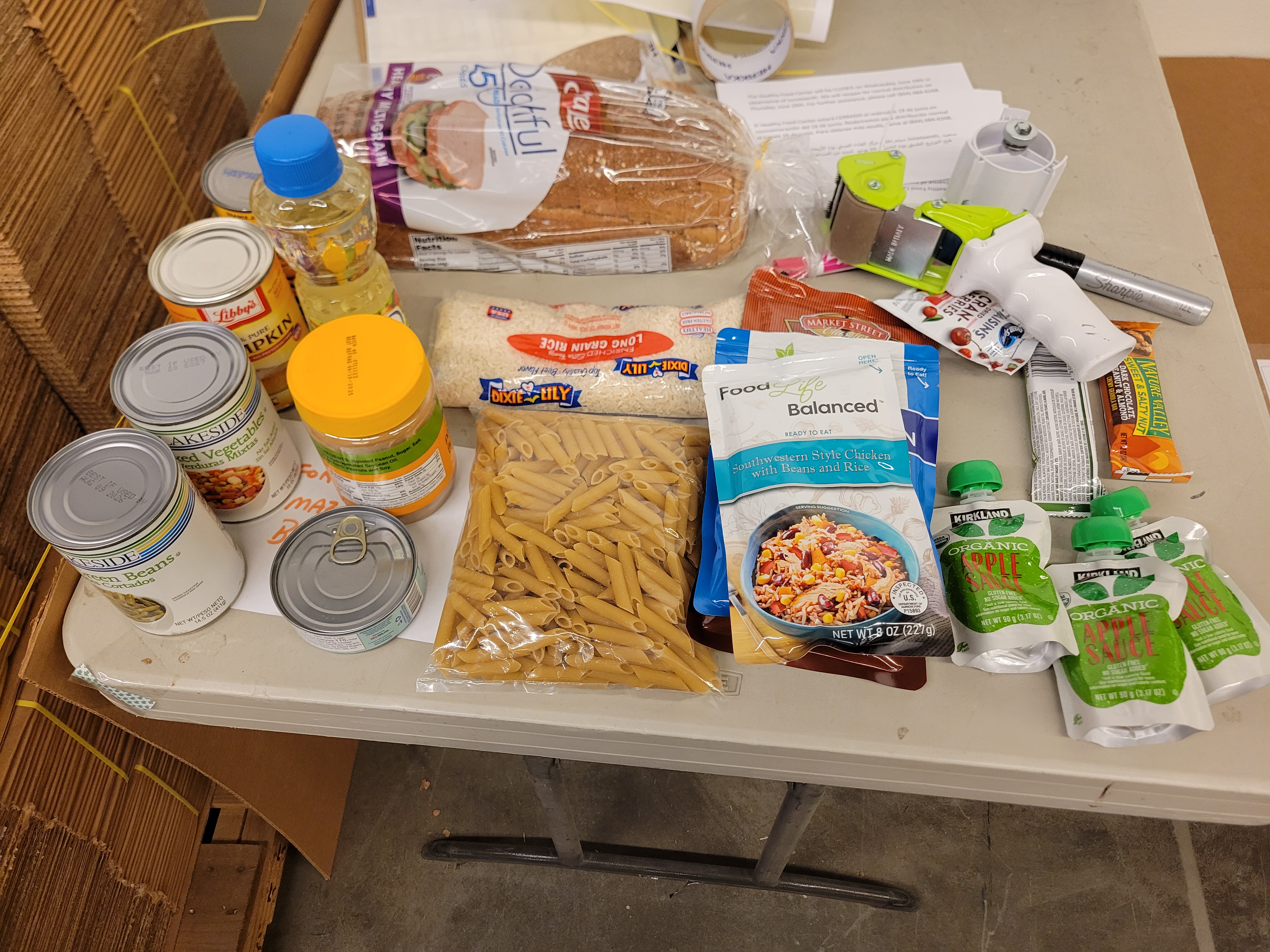Various food items such as bread and canned goods for a sample box.