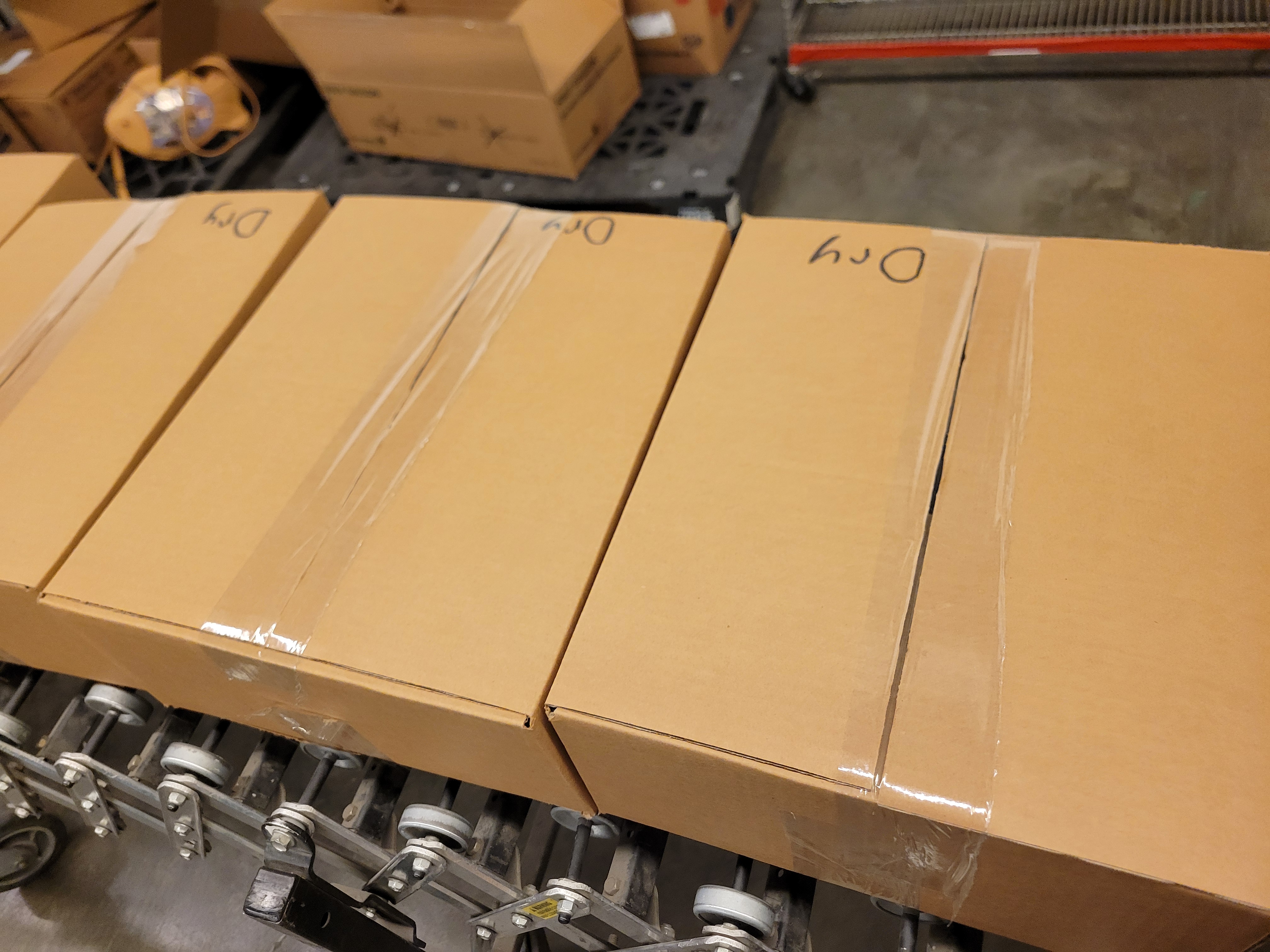 Taped cardboard boxes with the words dry on it.