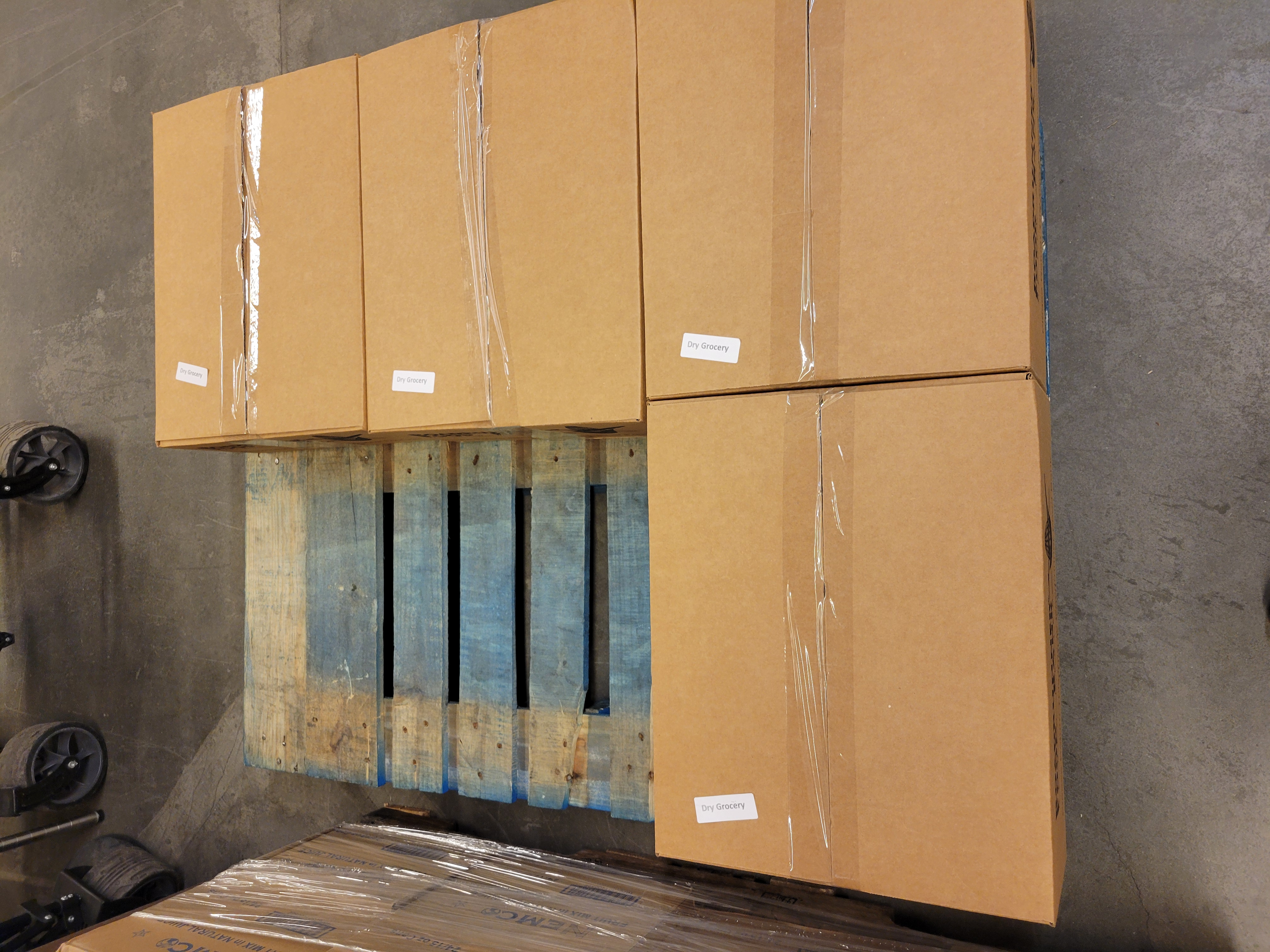 Four cardboards boxes on a pallet.