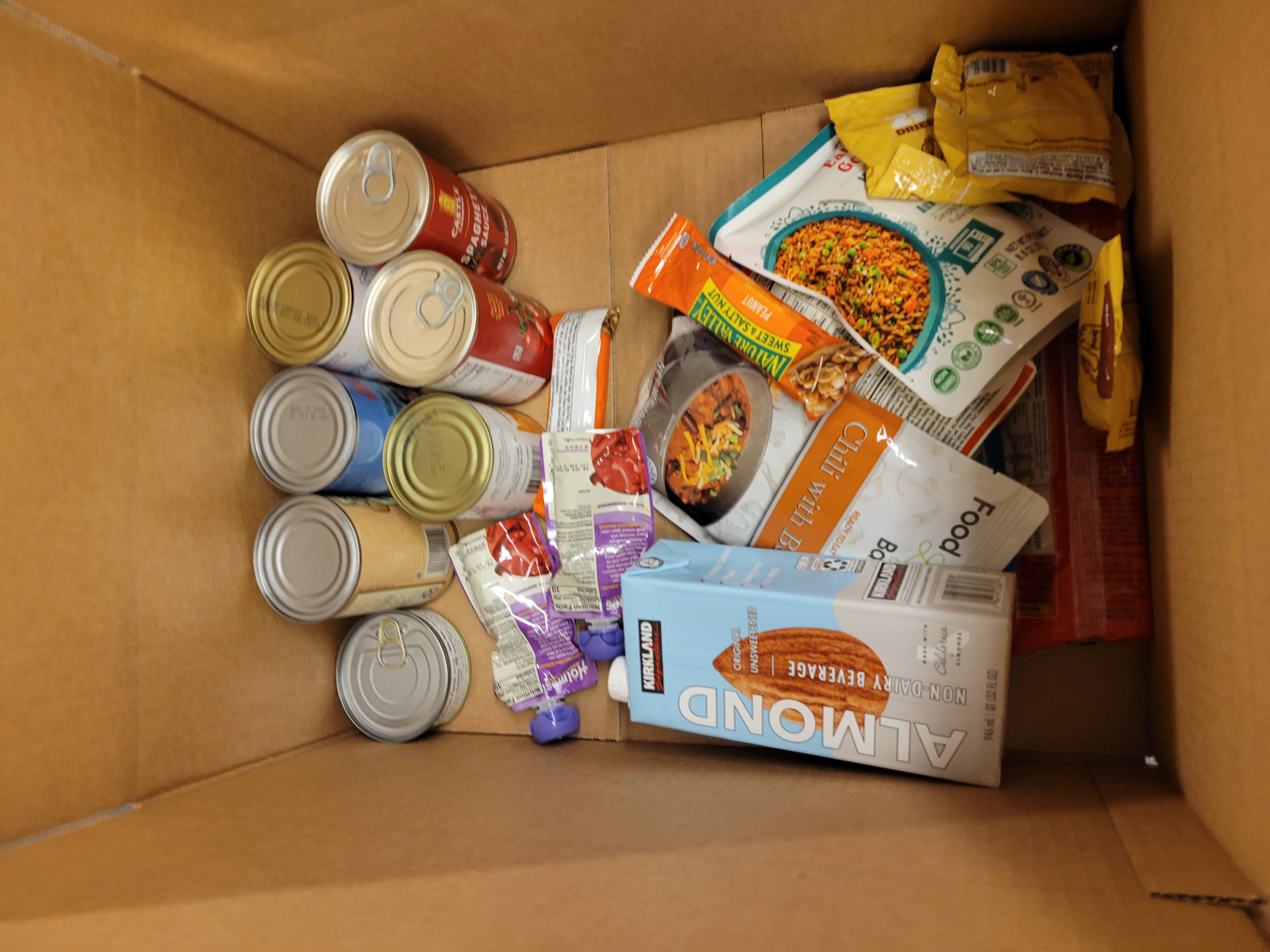 Cardboard box full of dry goods.