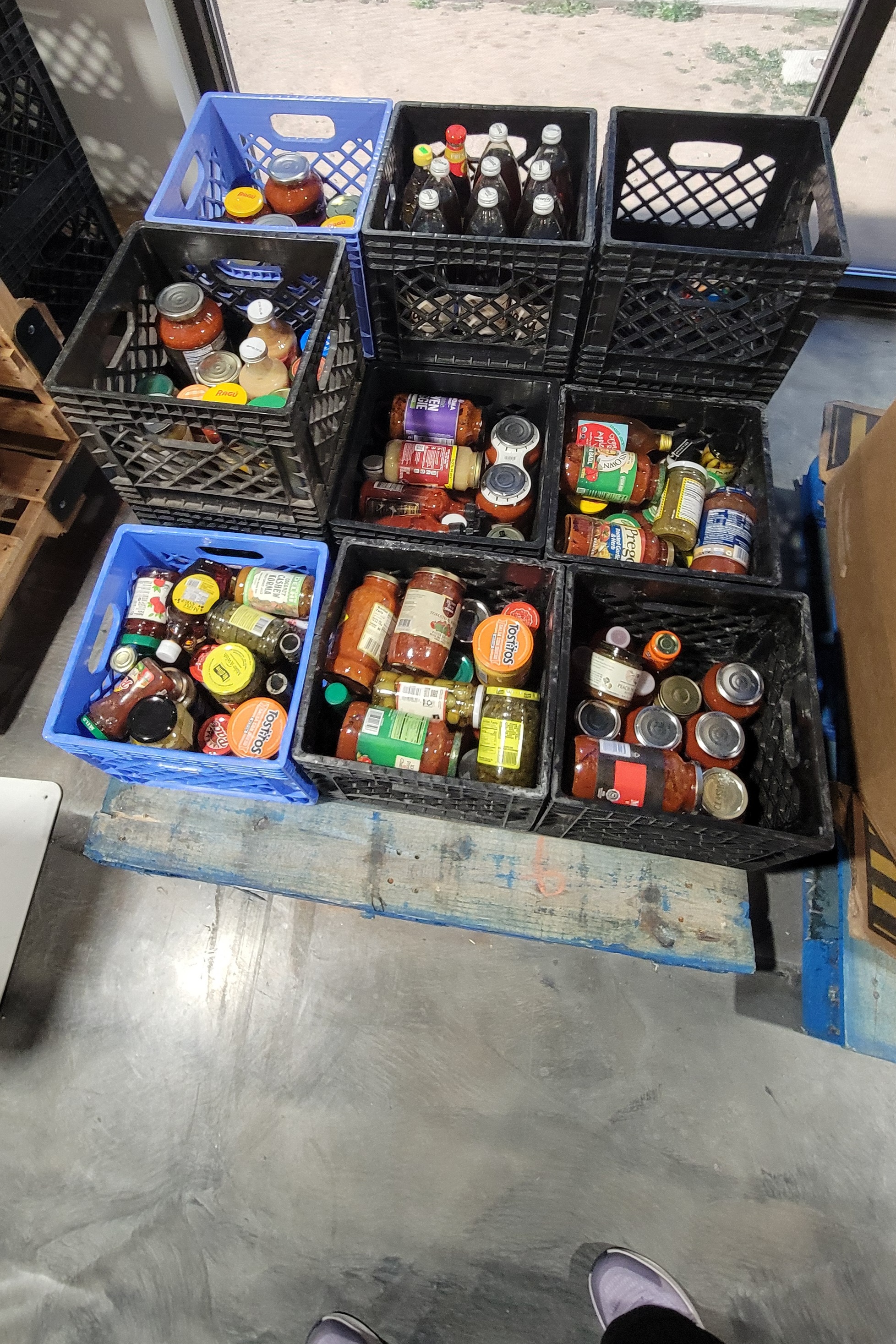 Crates filled with glass jars.
