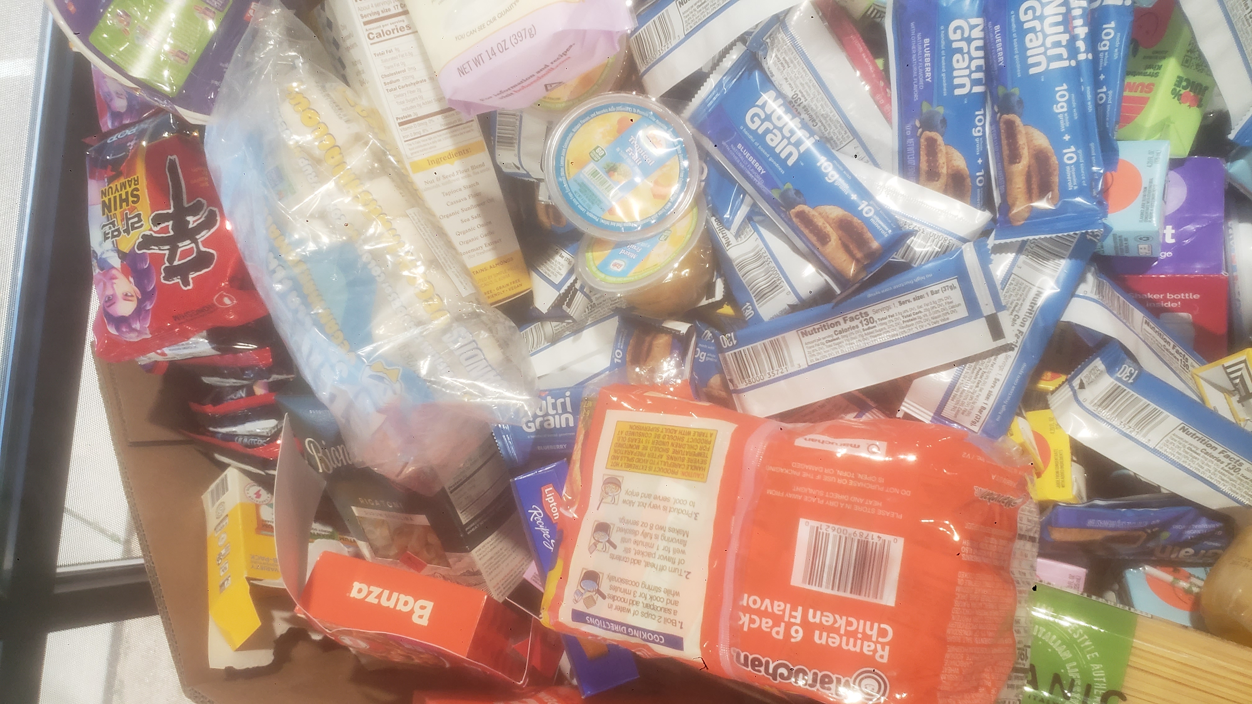 Cardboard container full of different foods.