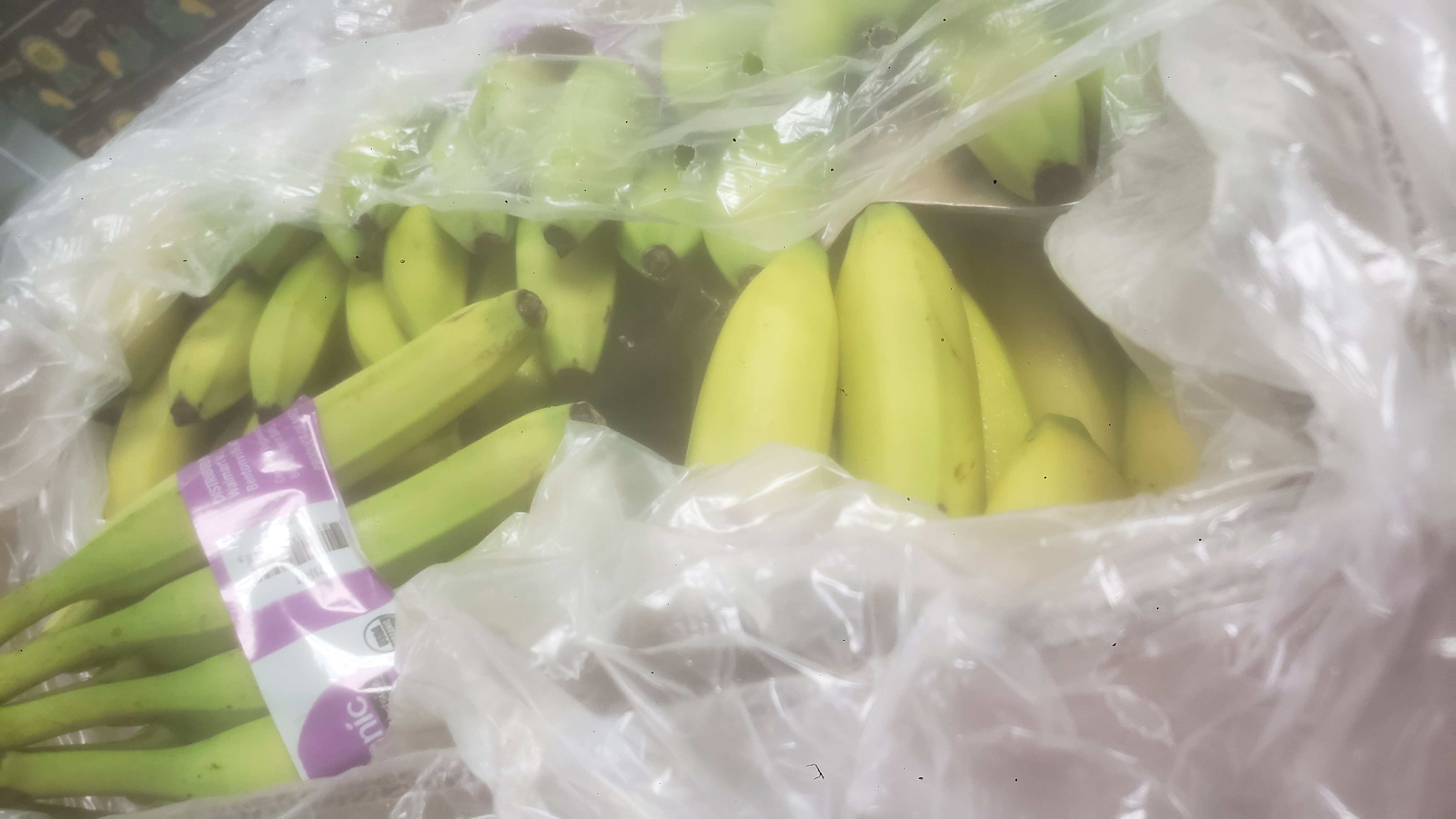 Bunches of bananas in plastic.
