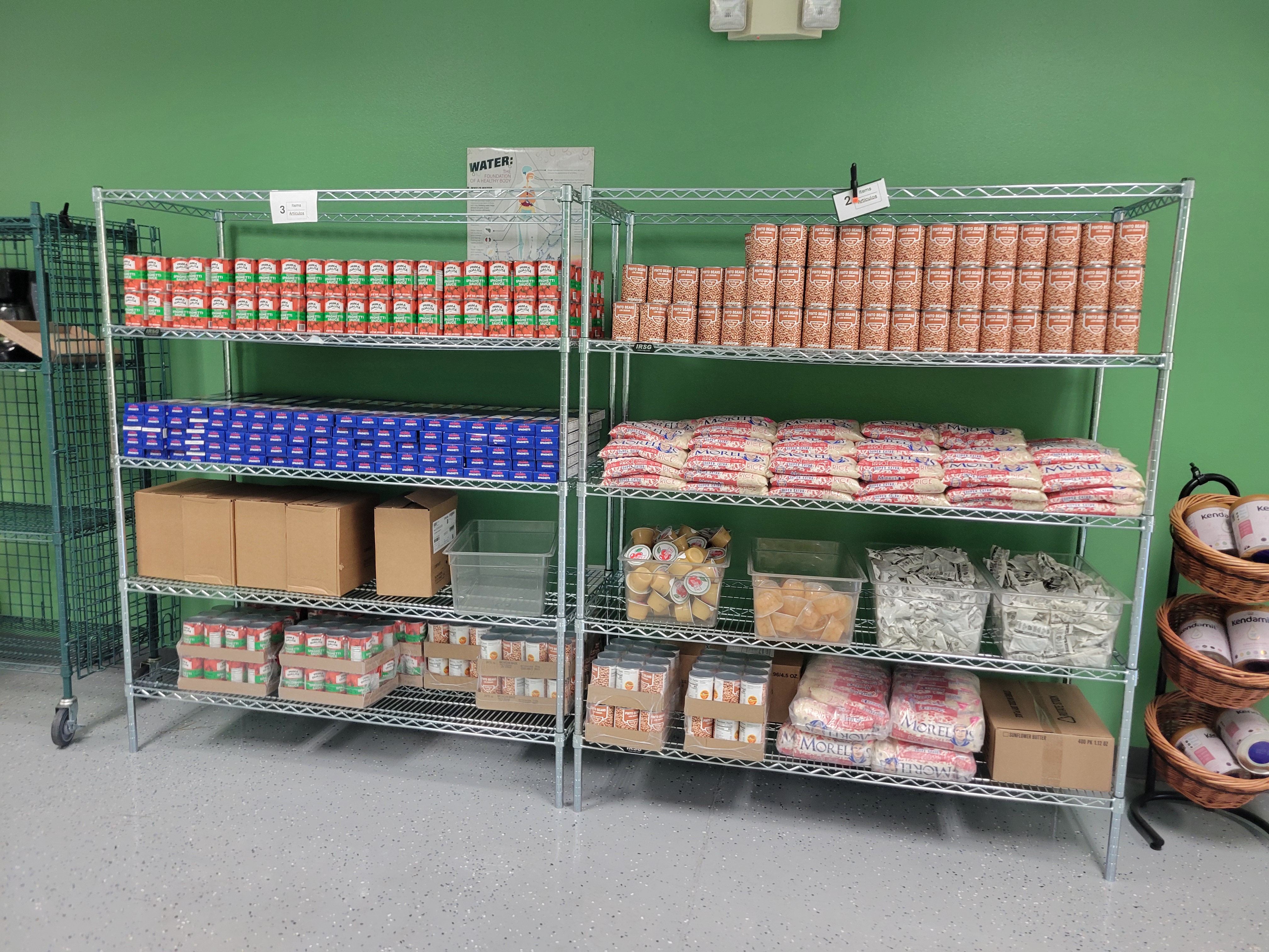 Two four tier shelves full of dry goods.