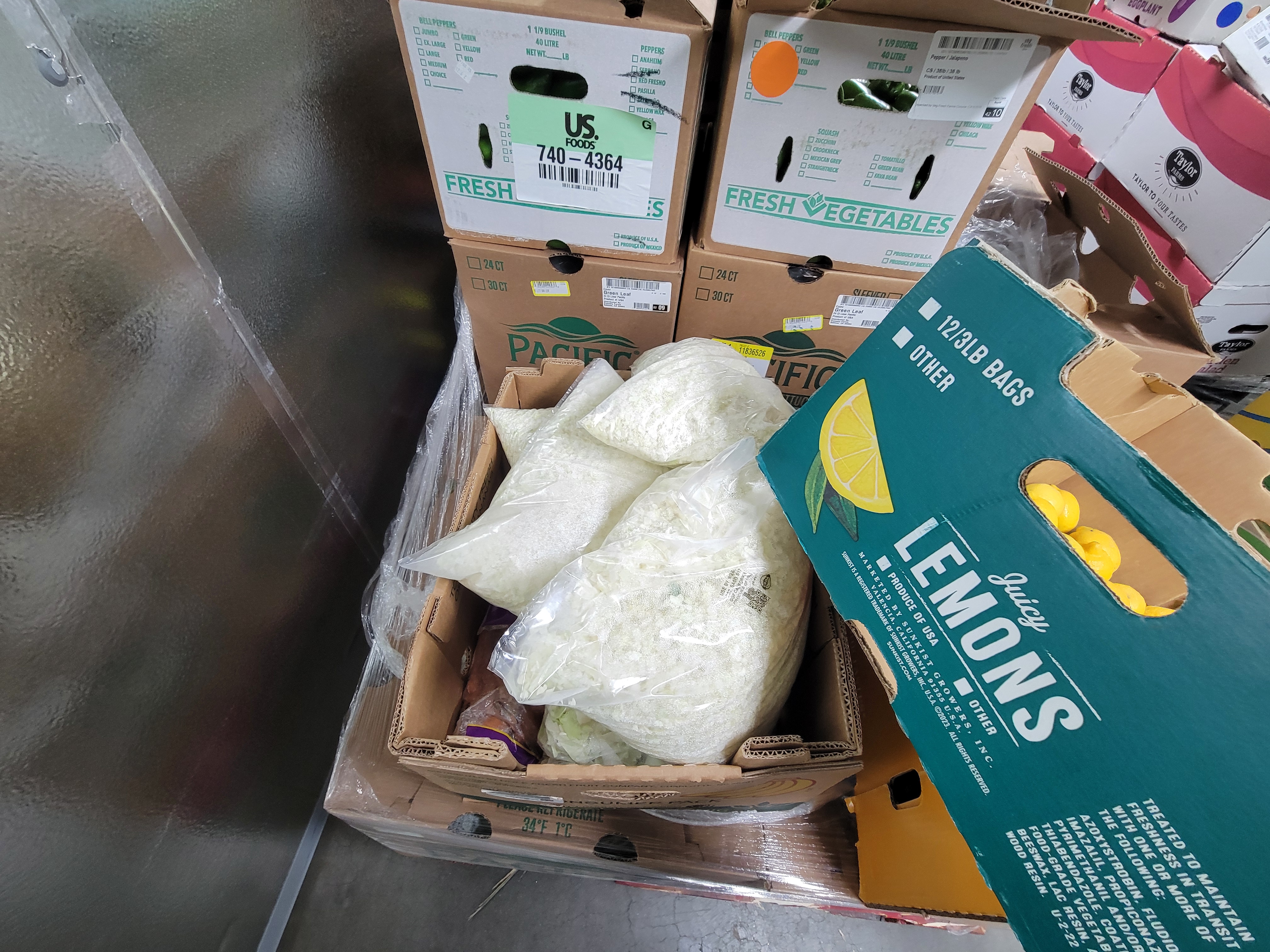 Boxes of produce in a fridge box unit.