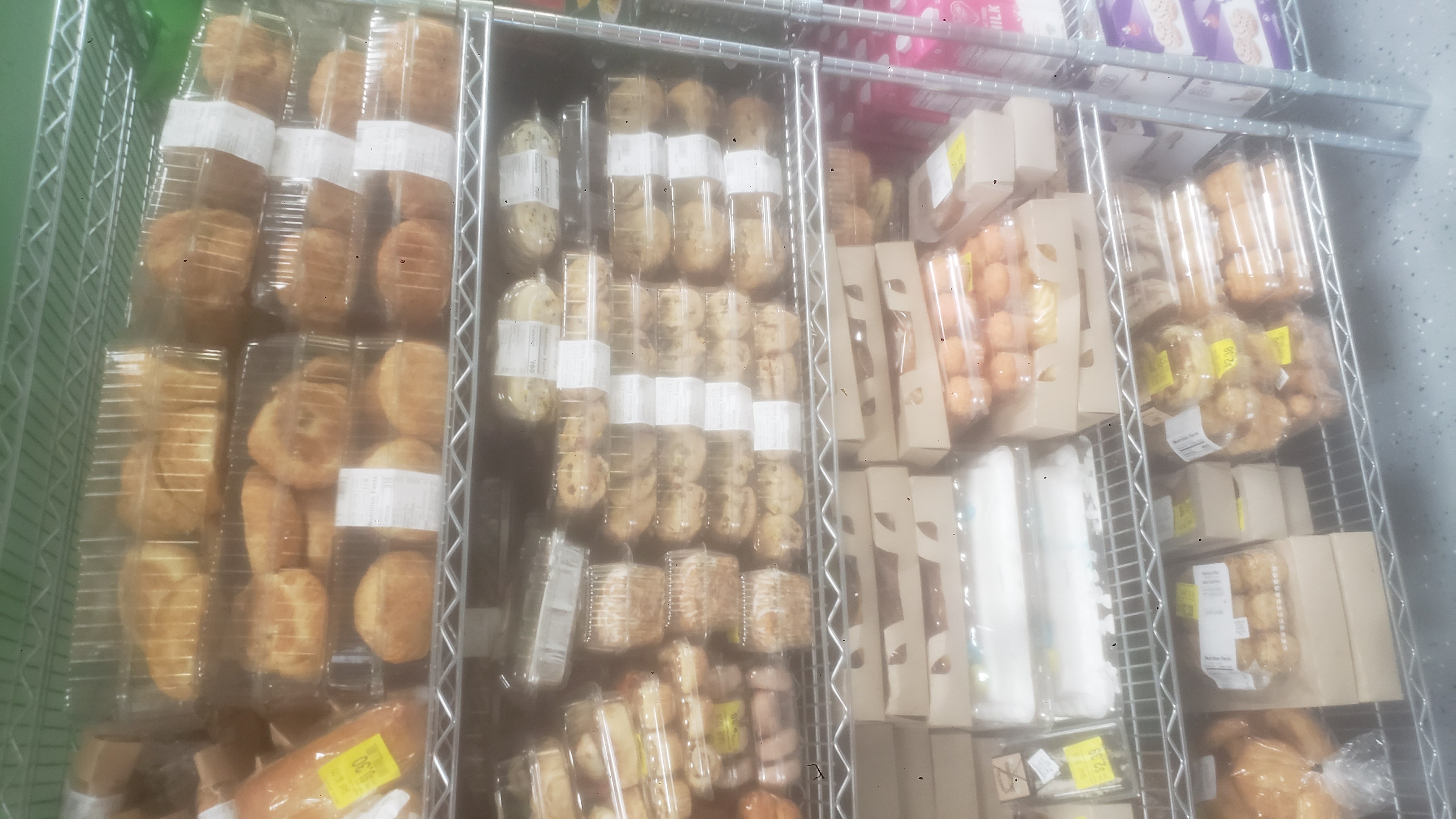 A variety of packaged baked goods on a shelf.