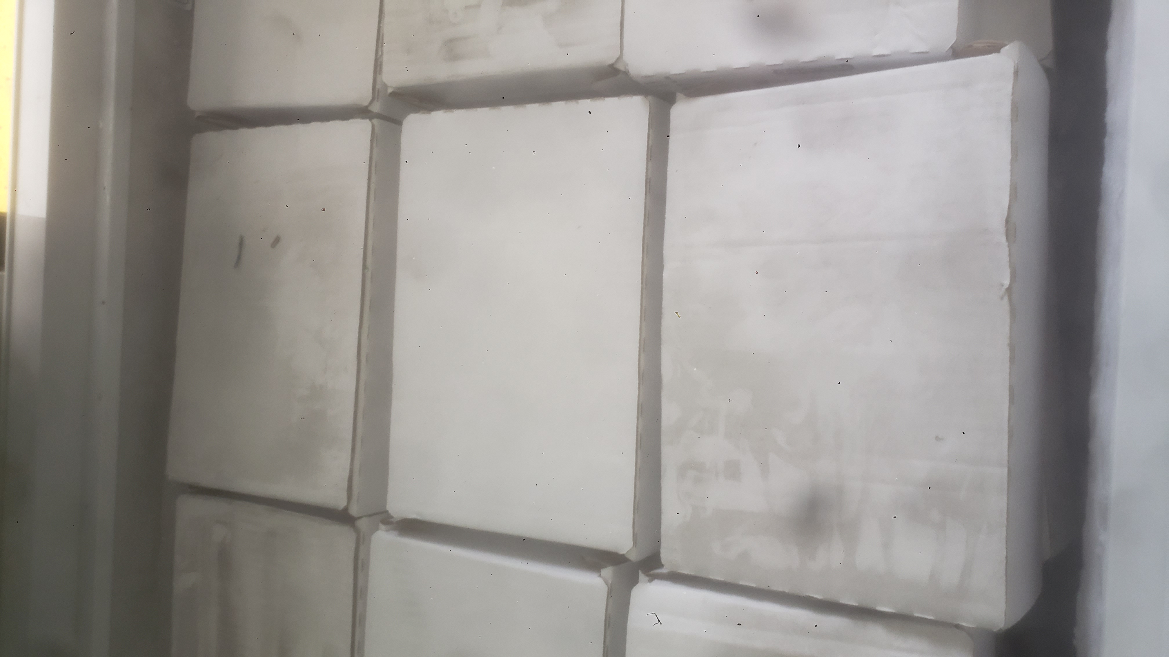 Cardboard boxes in a chest freezer.