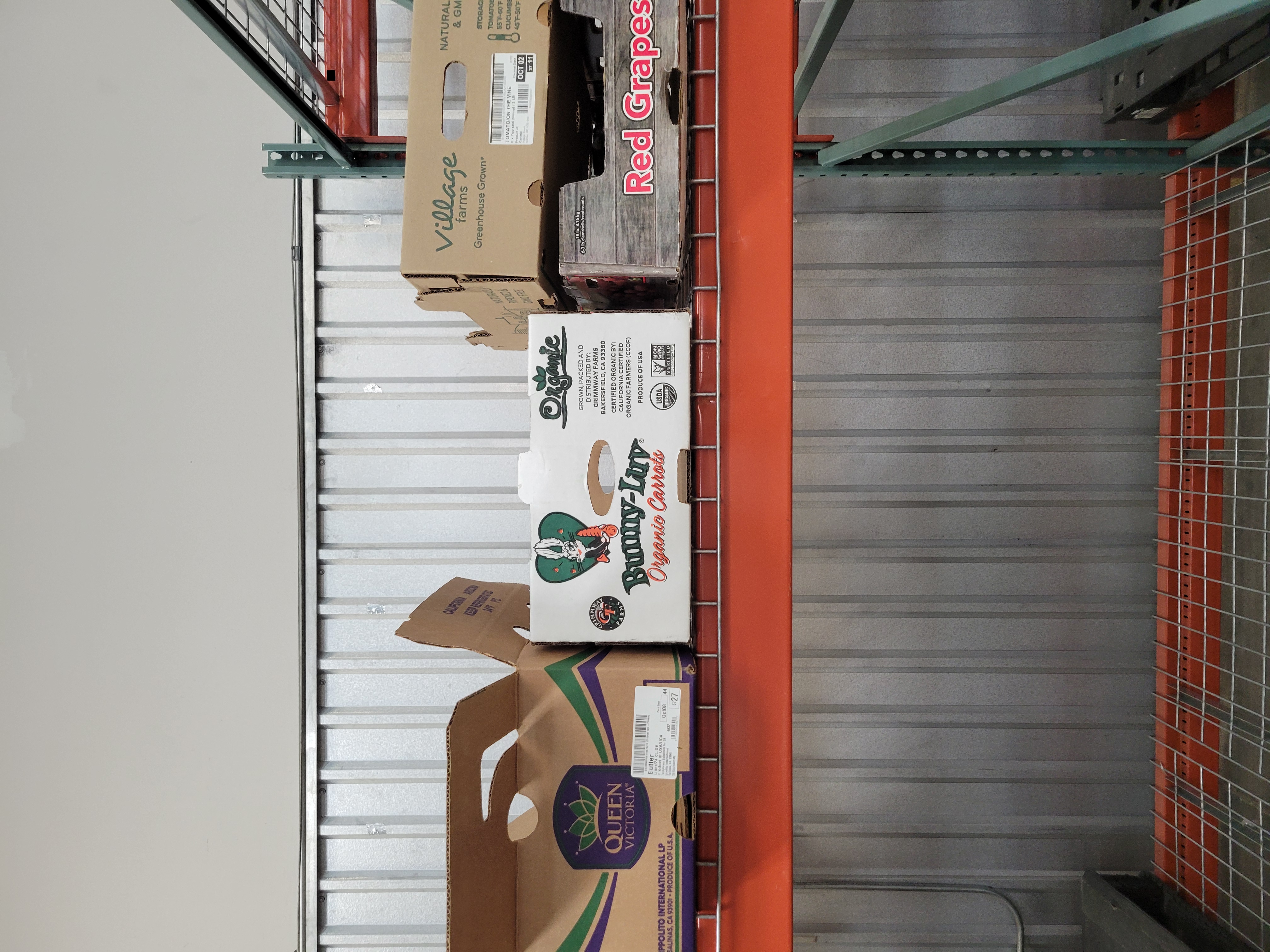 Fruit boxes on a shelf.