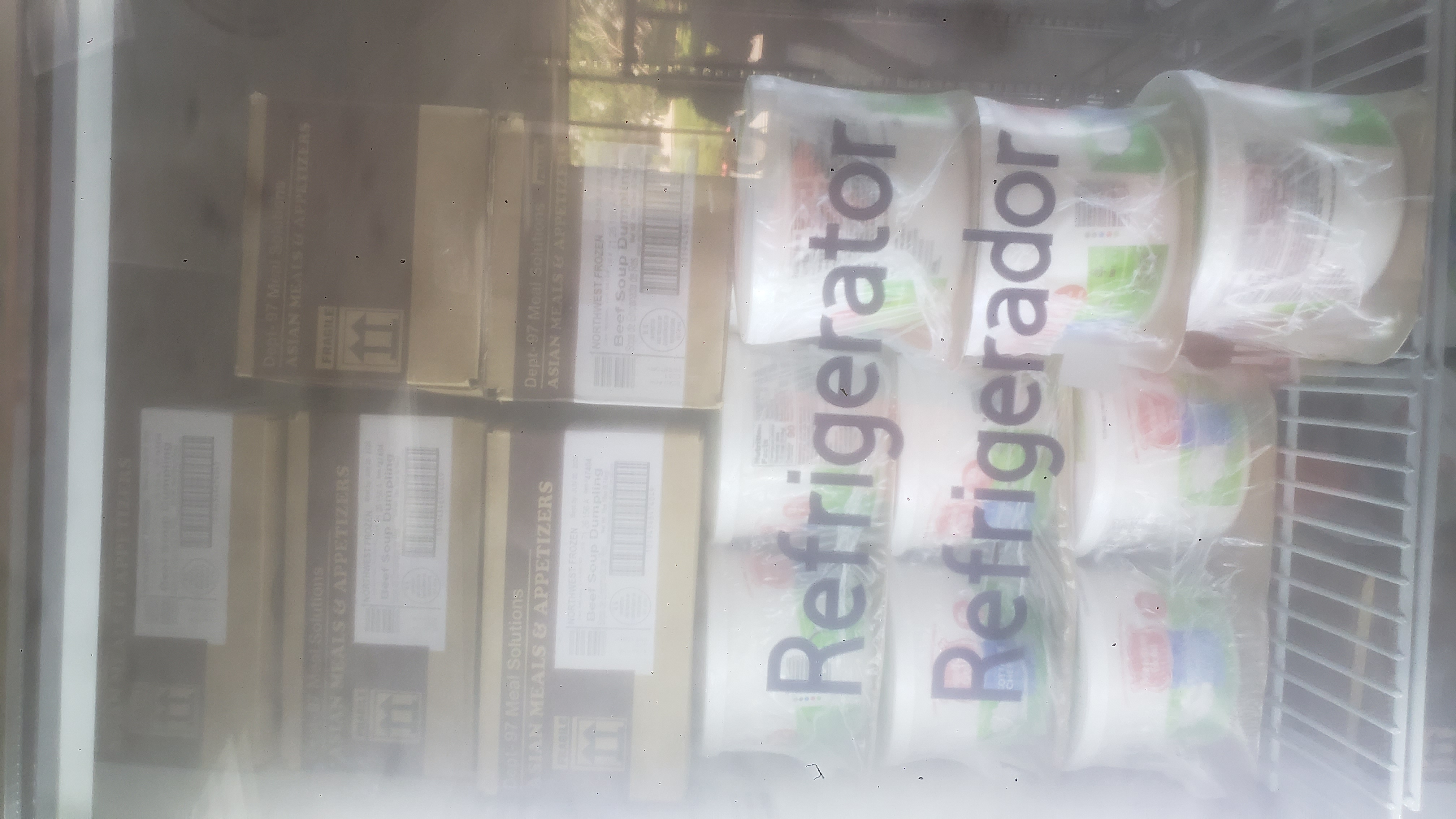 Boxes of beef dumpling soup on top of tubs of cottage cheese.