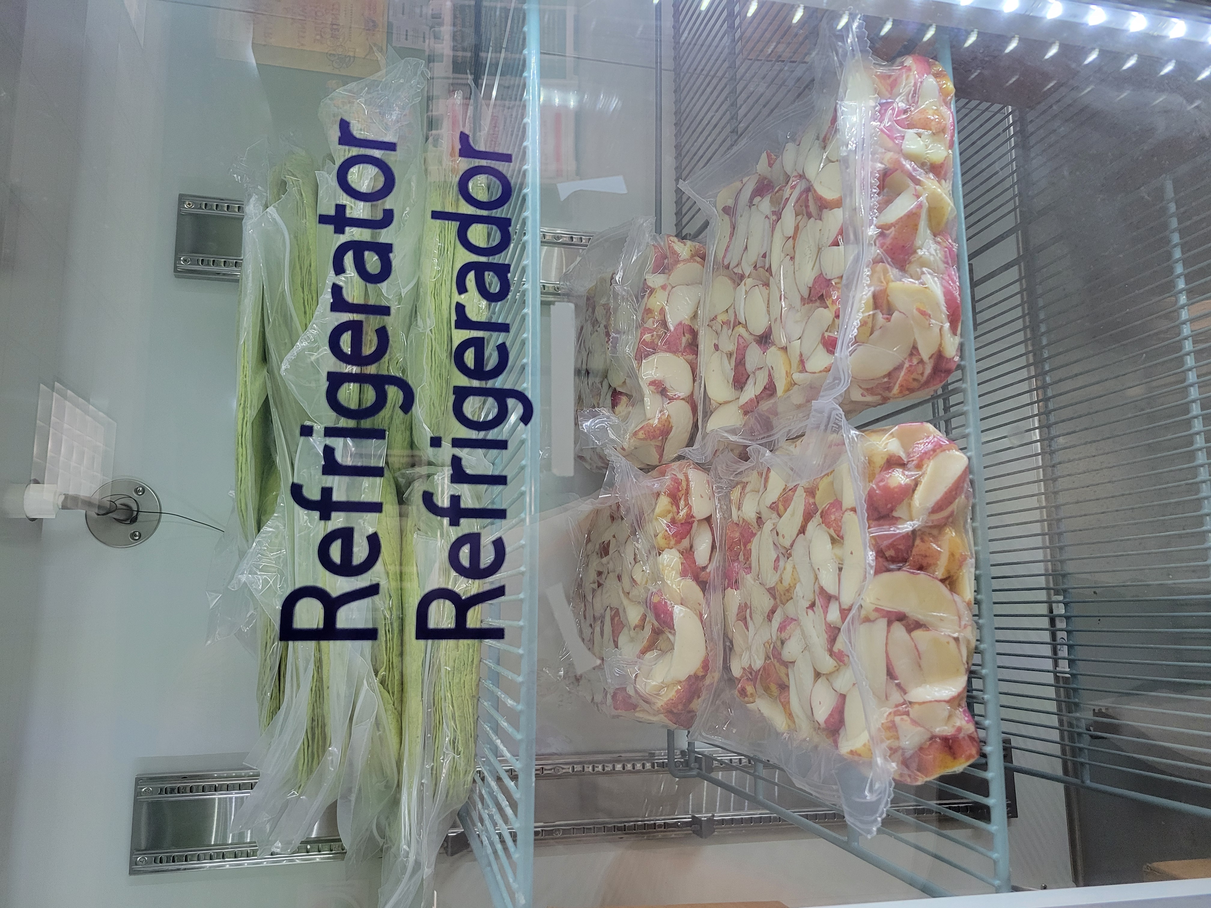 Boxes of various produce in a box fridge unit.