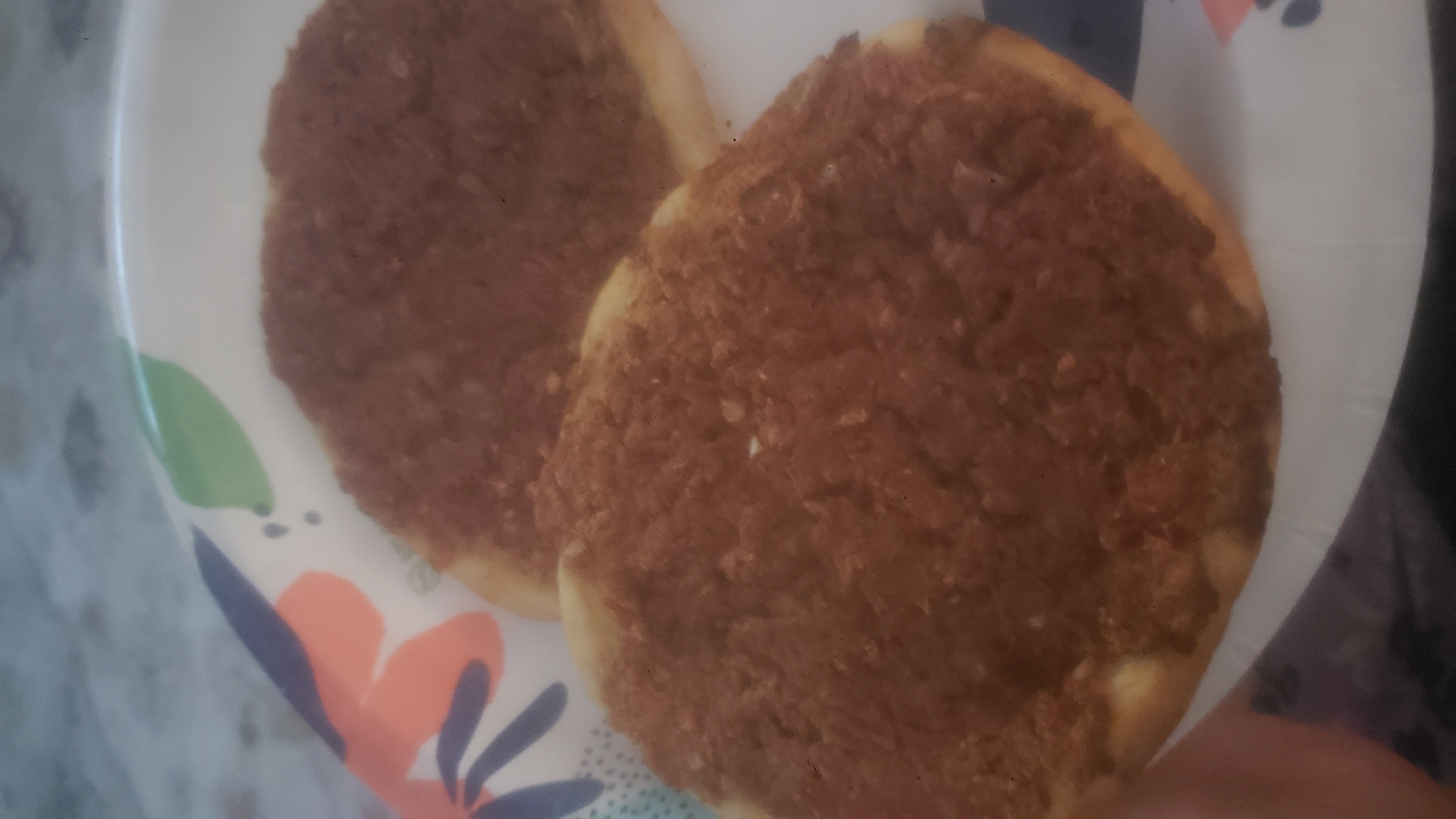 Two lahmacun on a paper plate.