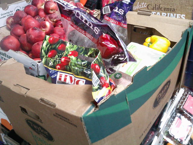 Stacks of produce trays full of rotten produce.