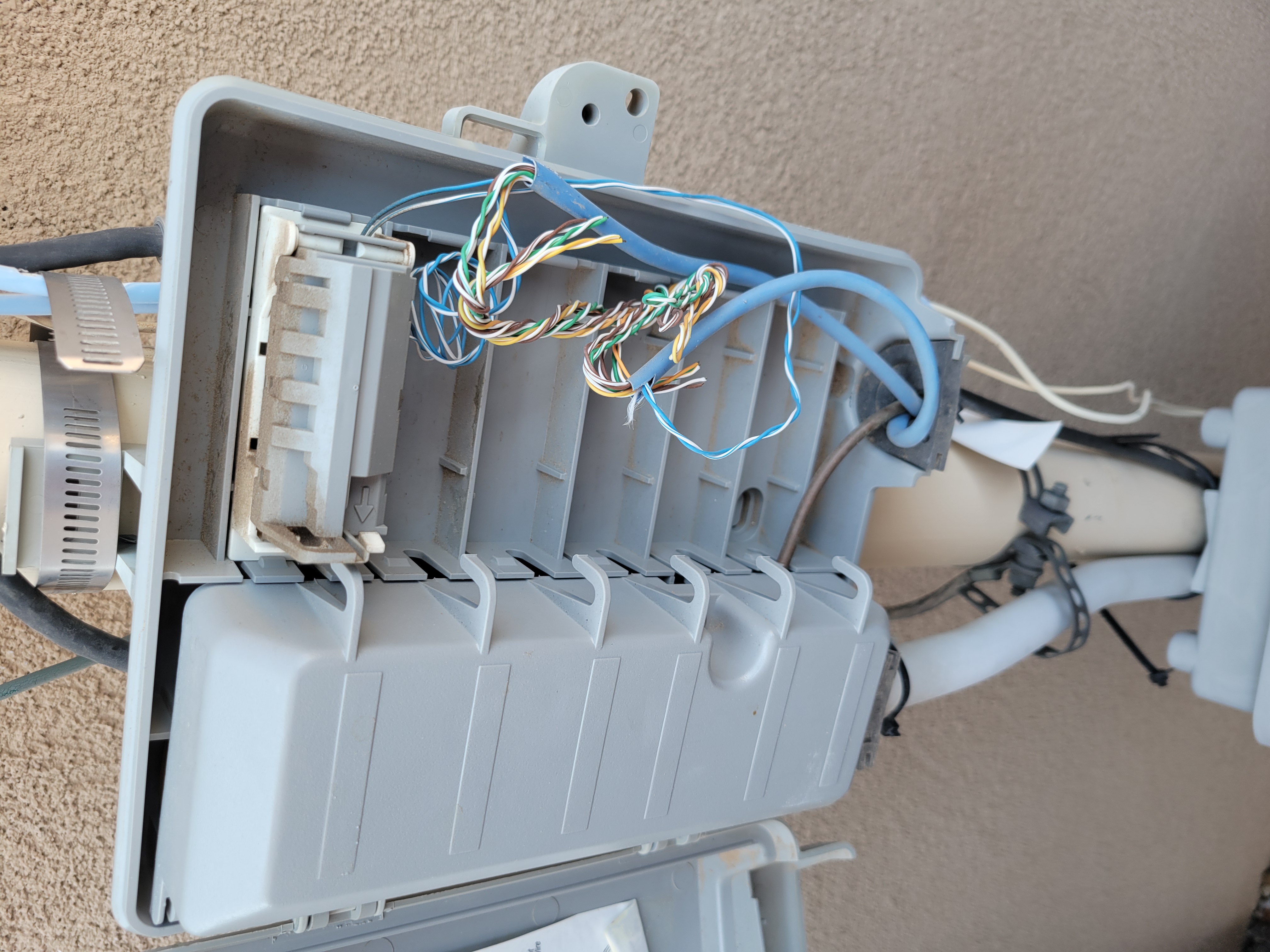 Open box of tore up telelphone wiring.