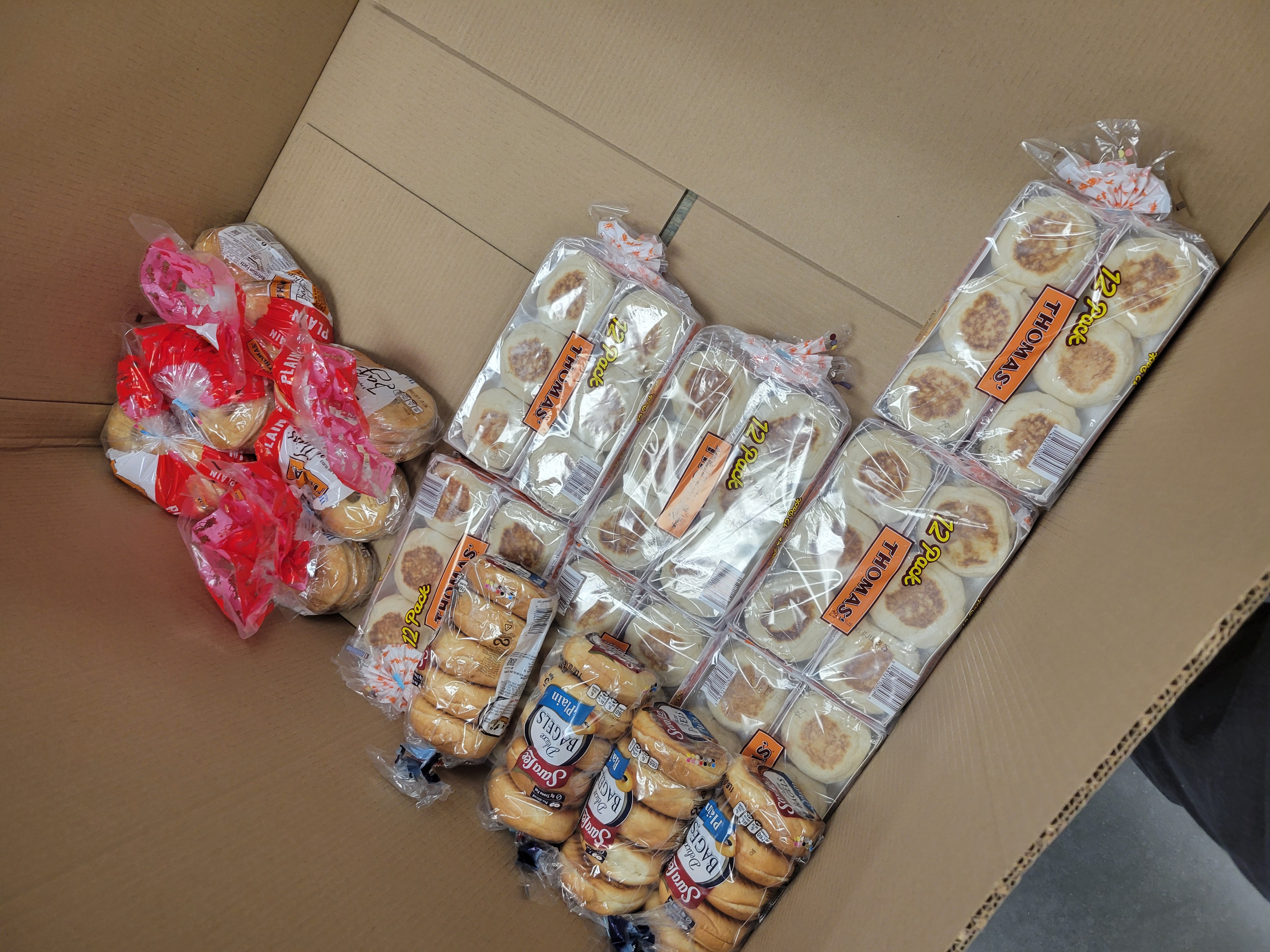 Different breads on bottom of cardboard container.