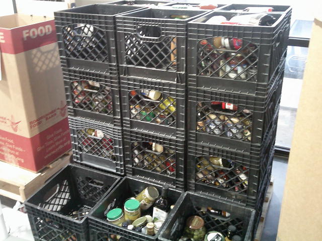 Rows of crates filled with glass jars.