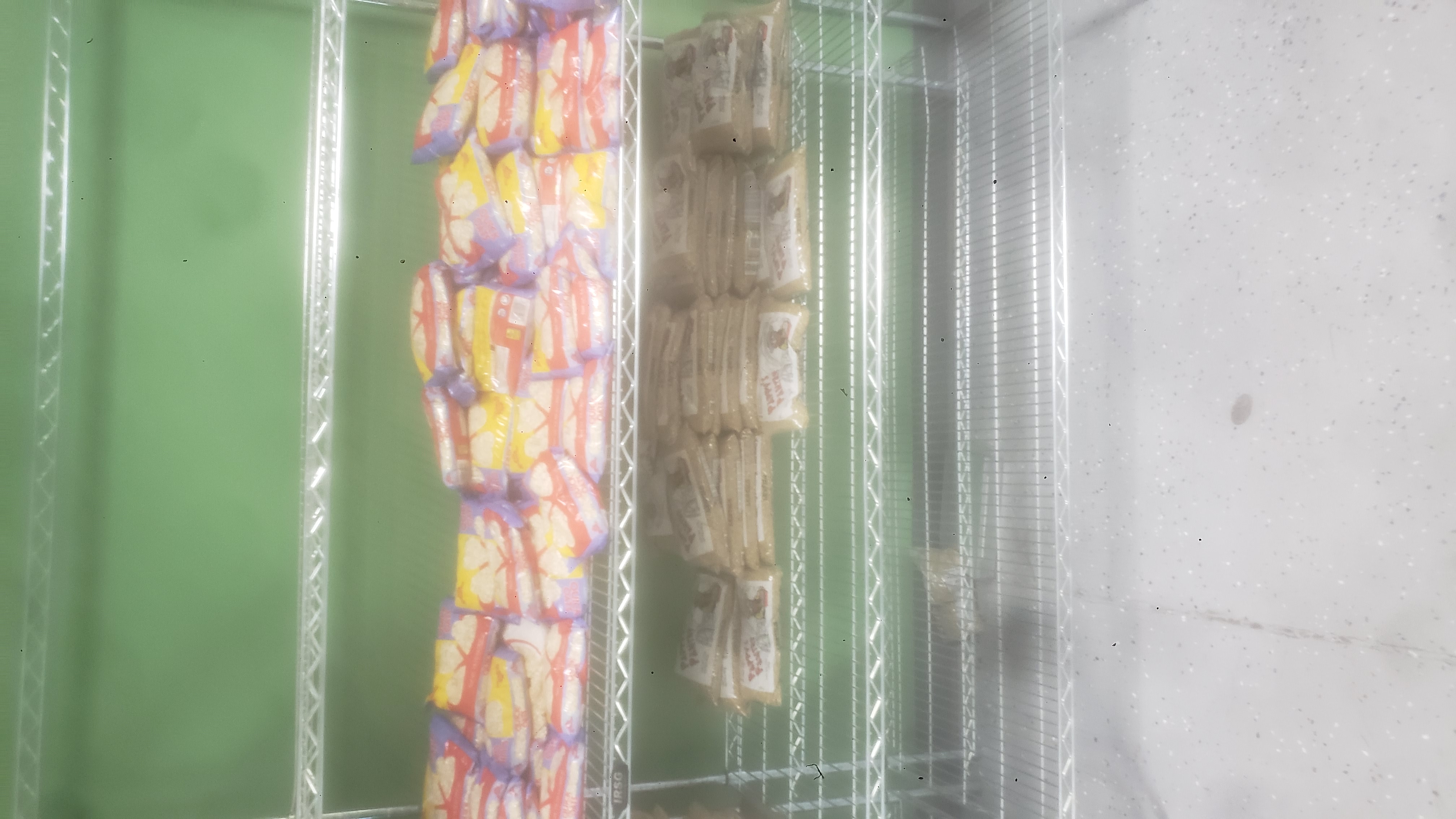 Bags of oatmeals and bags of lentils on a shelf.