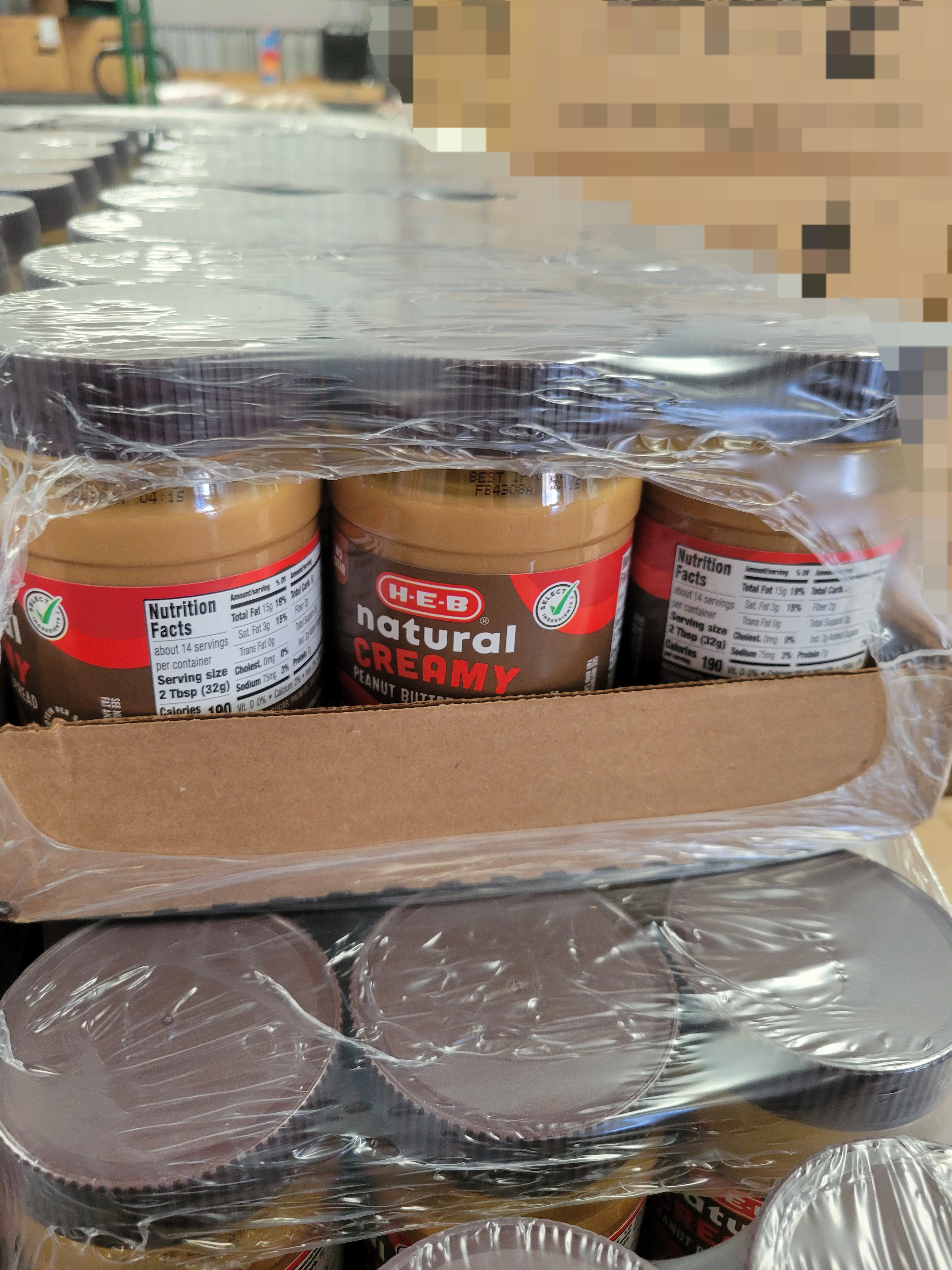 Trays of peanut butter covered with plastic.