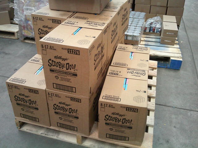 Boxes of Scooby-doo themed cinnamon crisp cereal on a pallet.
