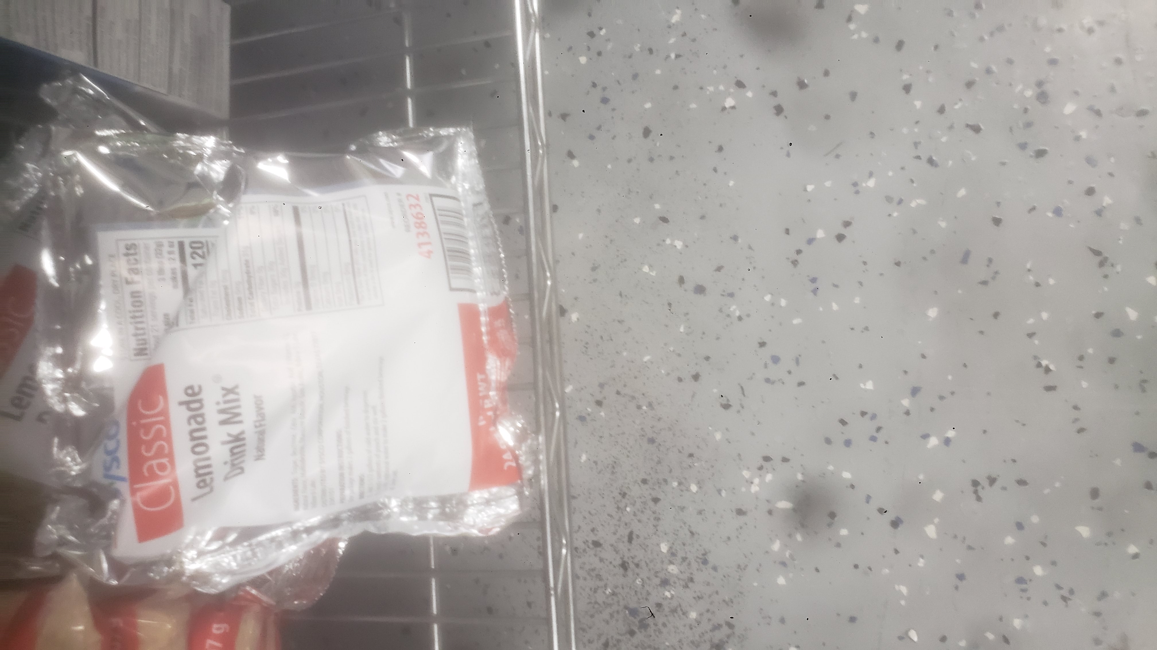 A bag of lemonade drink mix on a shelf.