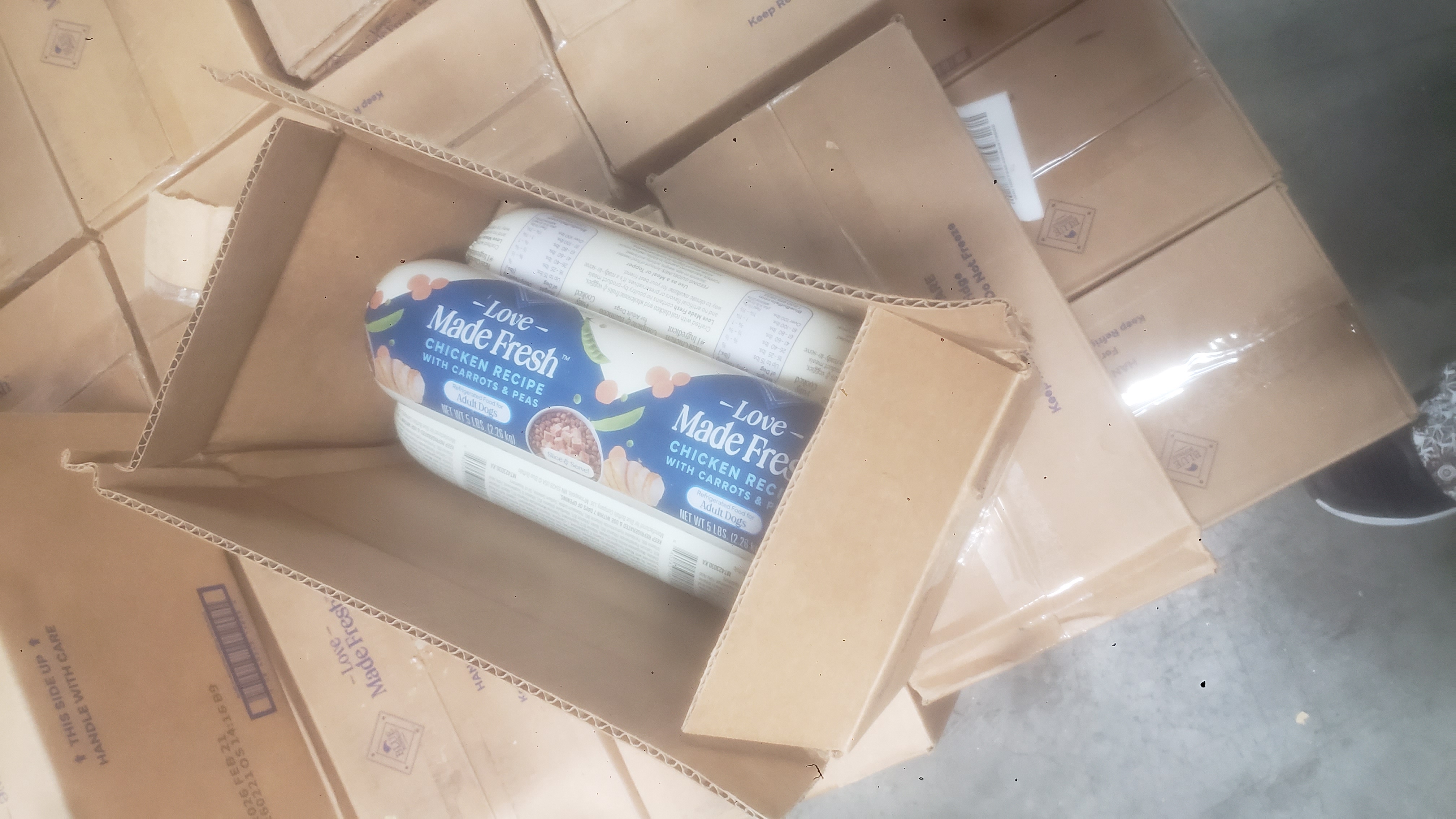 Cardboard boxes of log form of adult dog food.