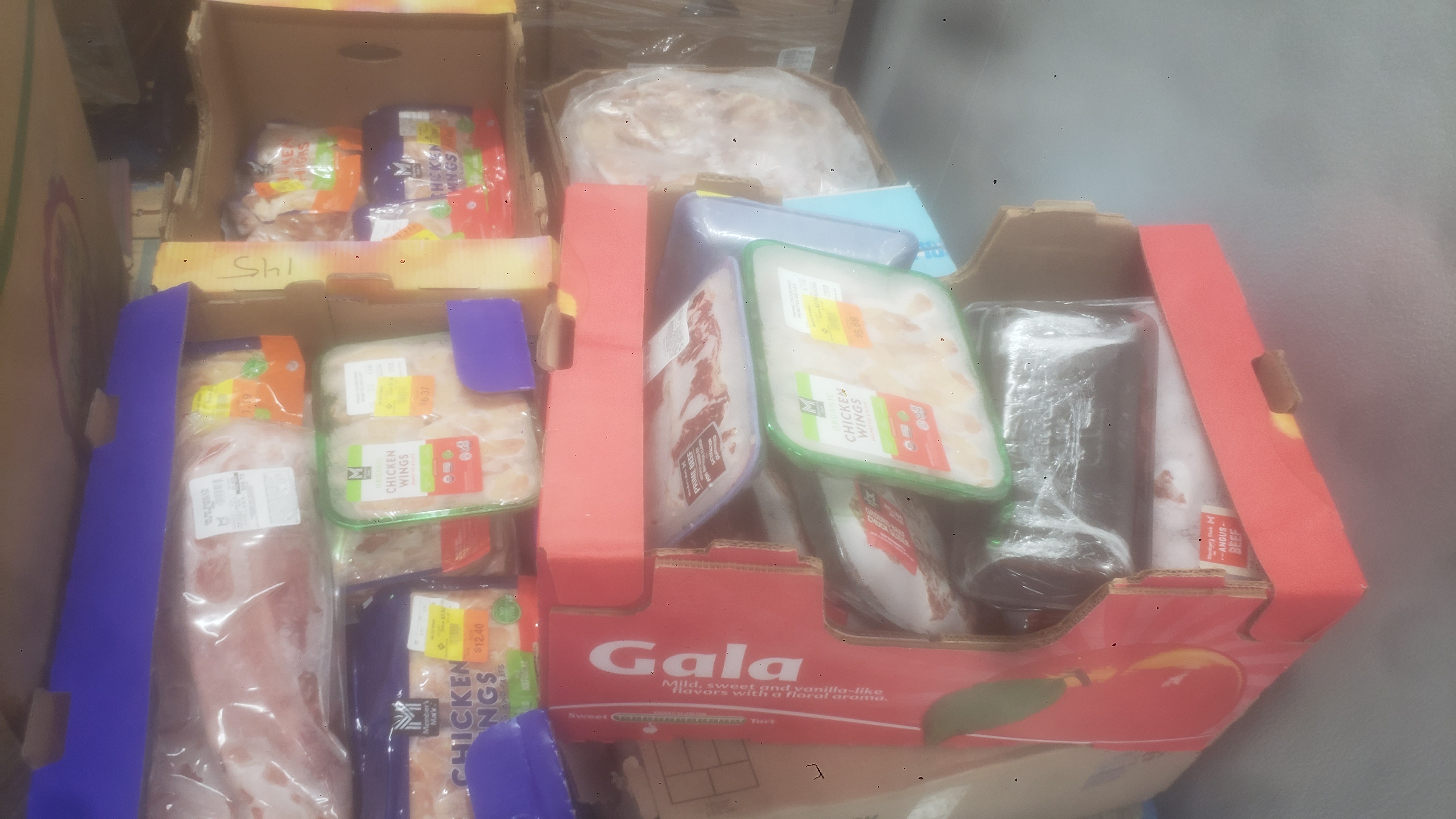 Assorted frozen items in cardboard boxes such as prime beef, beef chuck, and pork.