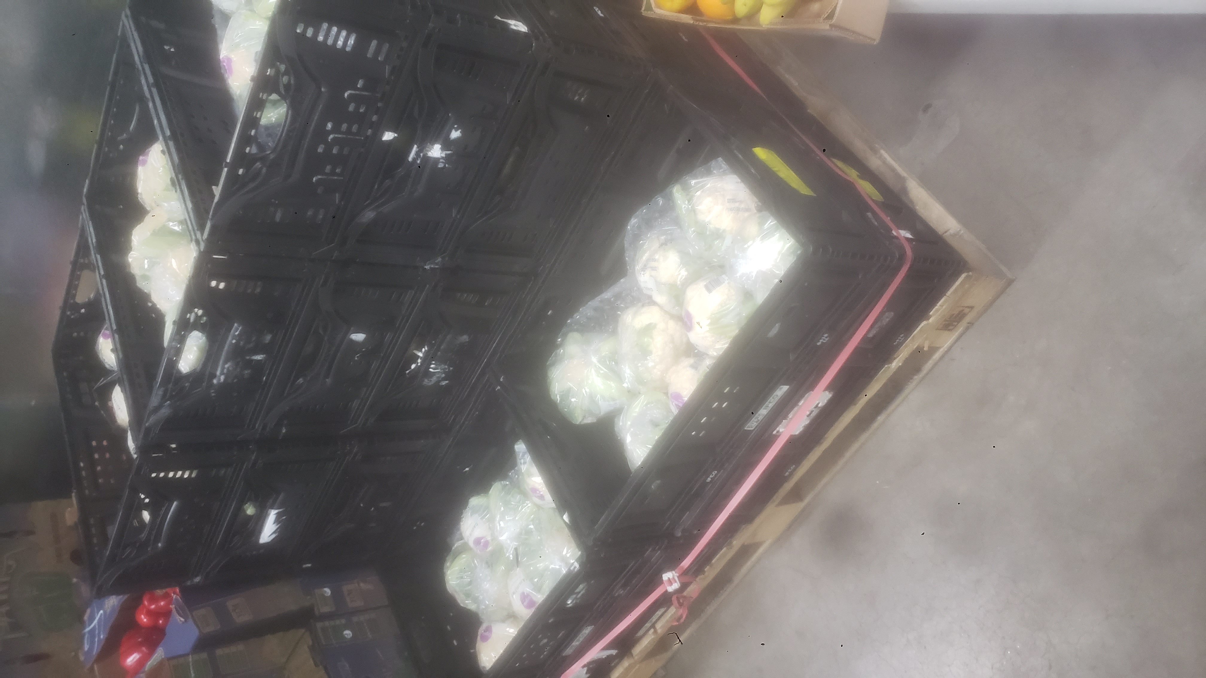 Crates full of cabbages on a pallet.