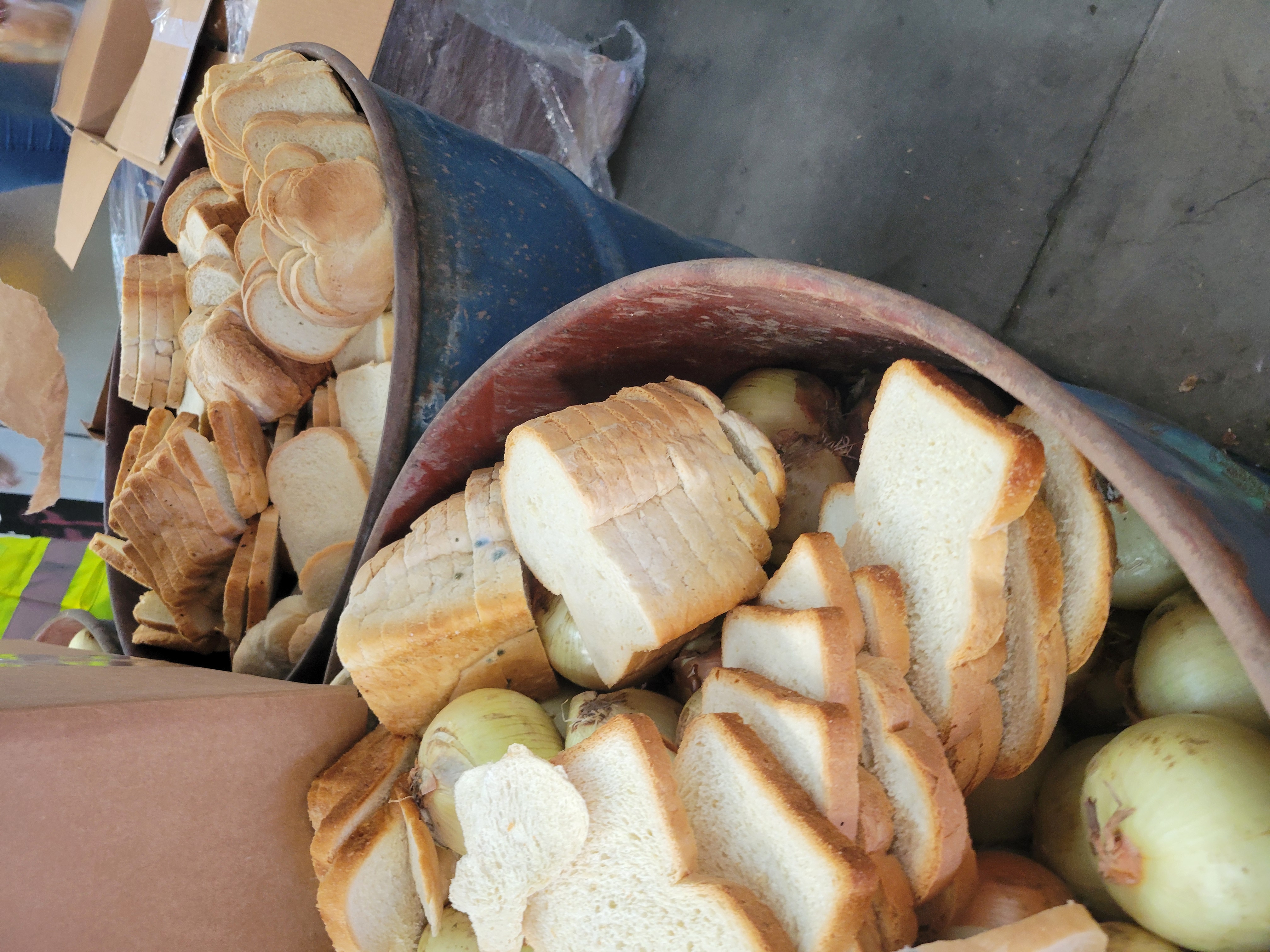 Rotten bread and onions in containers.