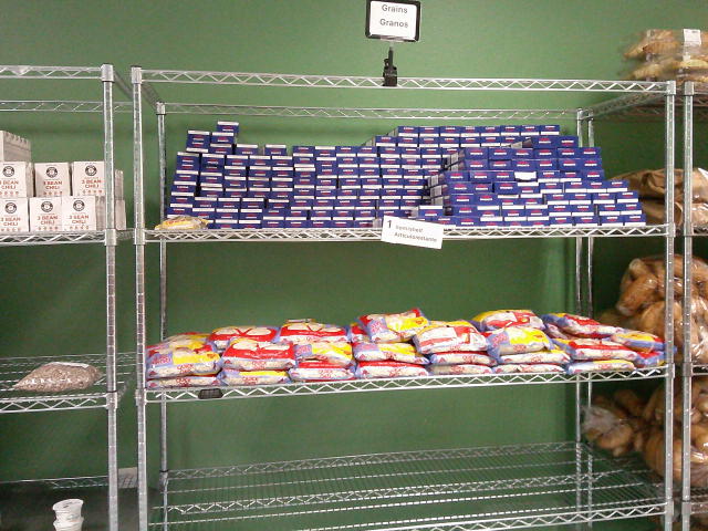 Boxes of spaghetti on the top shelf, bags of oats on the middle shelf and empty third shelf.
