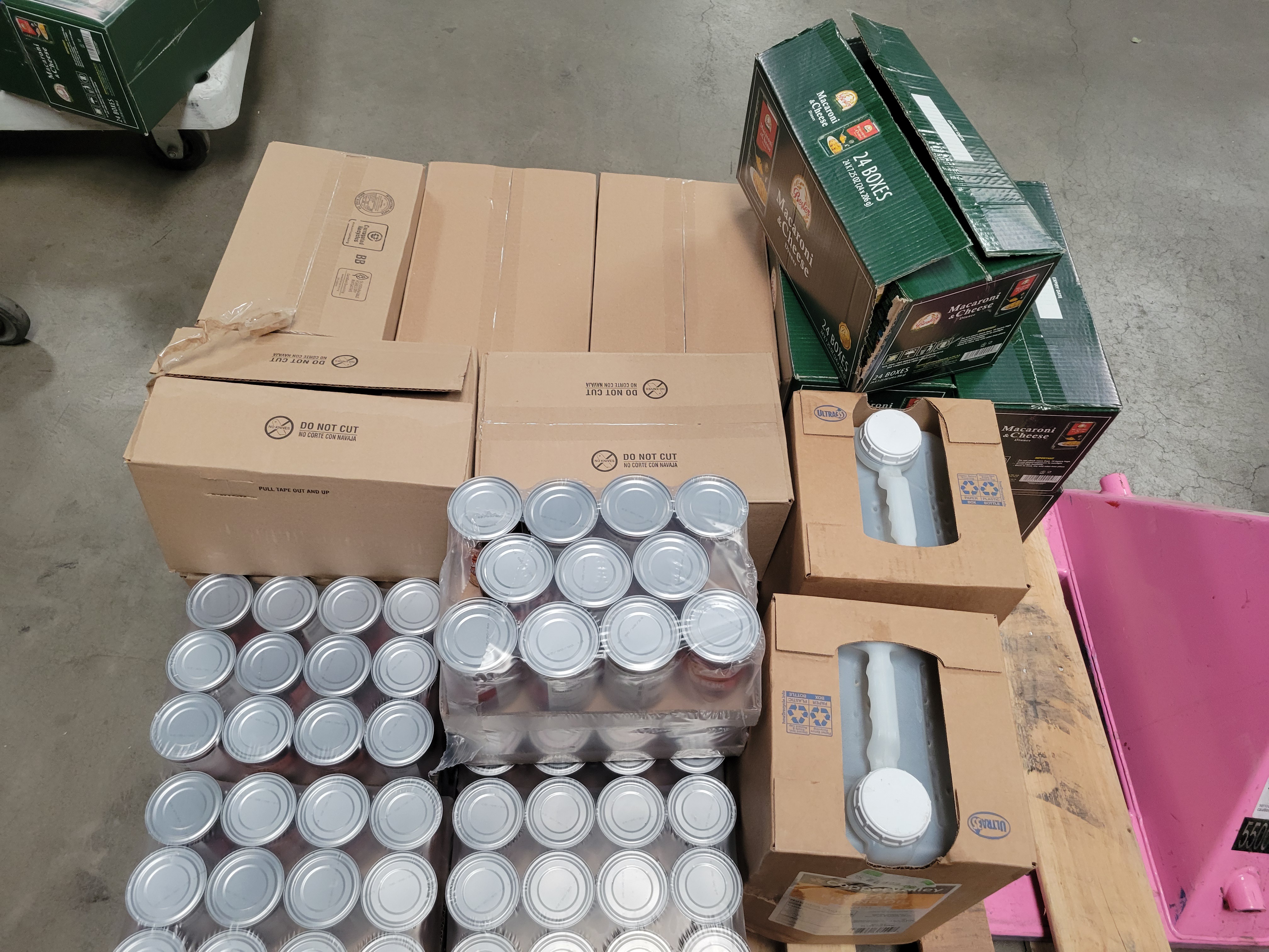 Boxes of dry goods and boxes of oil on a pallet.