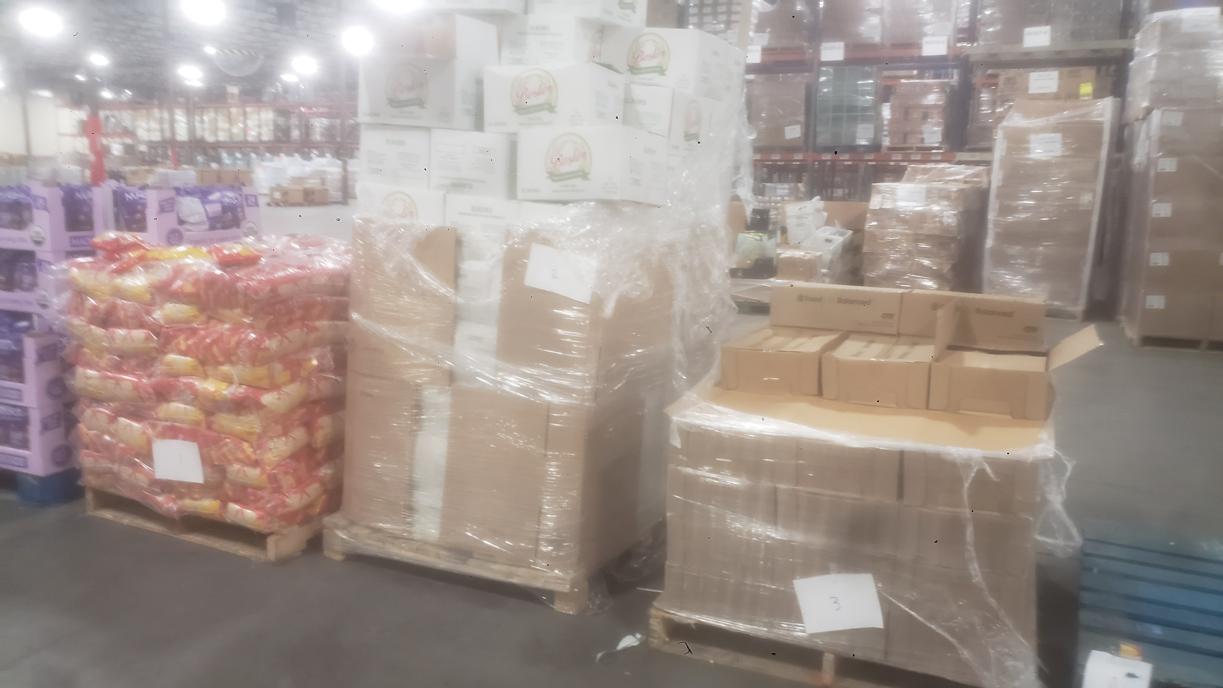 Pallets of dry goods and one empty pallet.