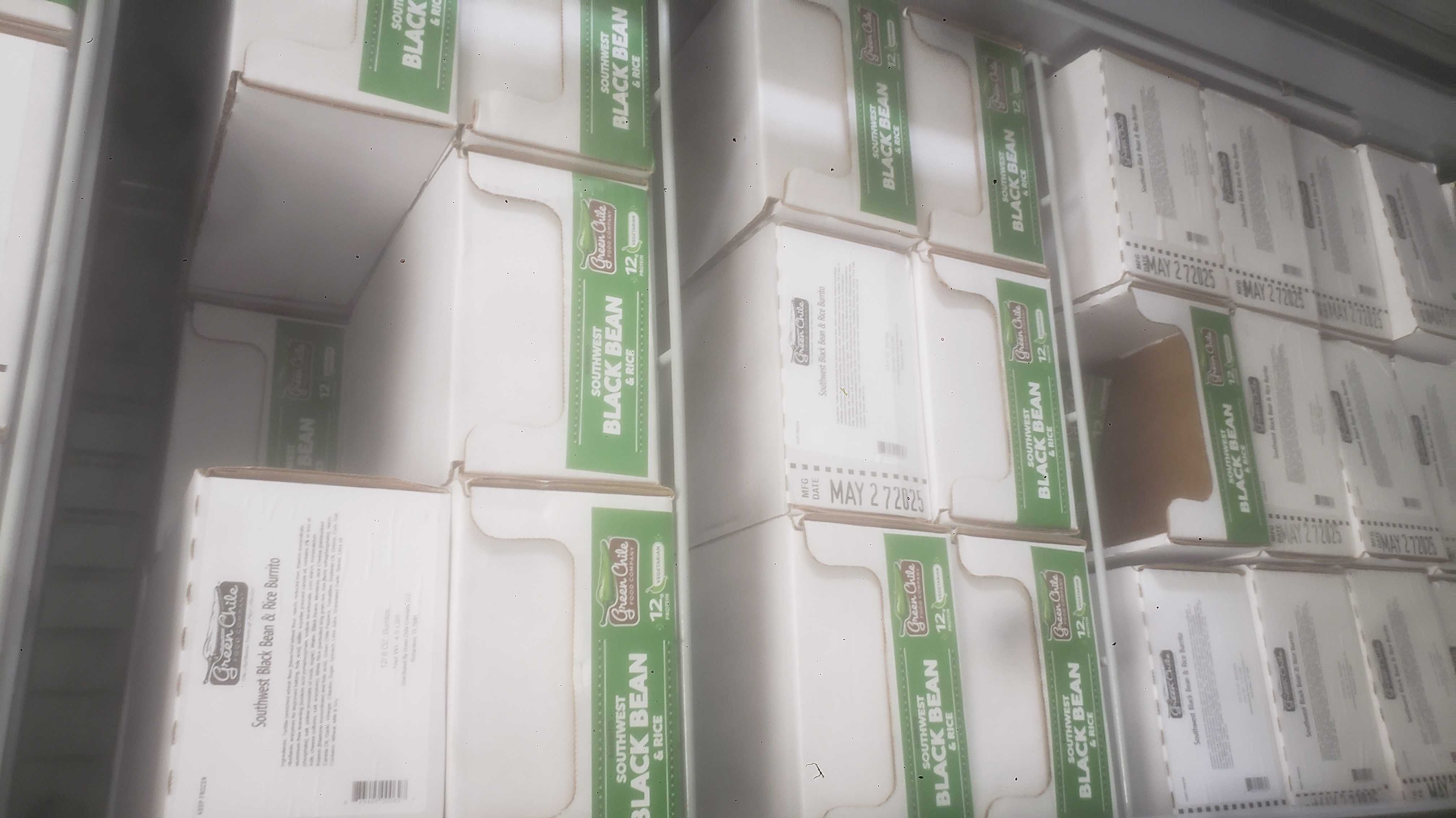 Cardboard trays of Southwest black bean & rice burritos.