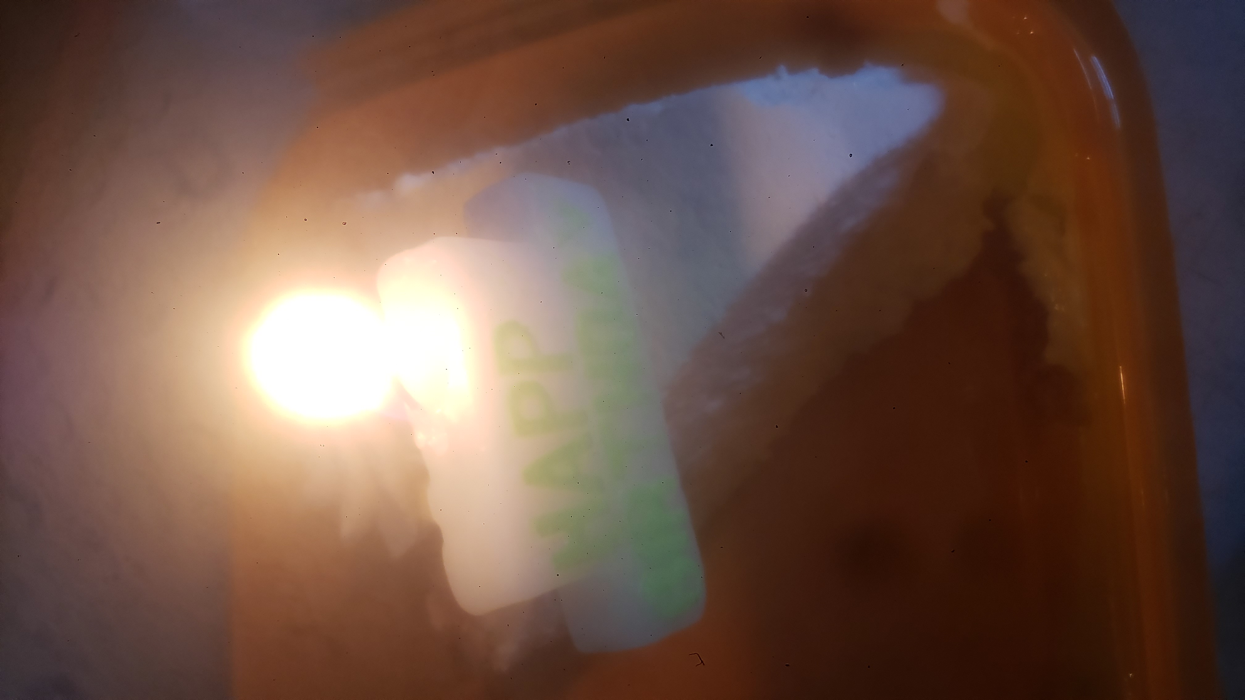 Slice of keylime candle with lit birthday candle.