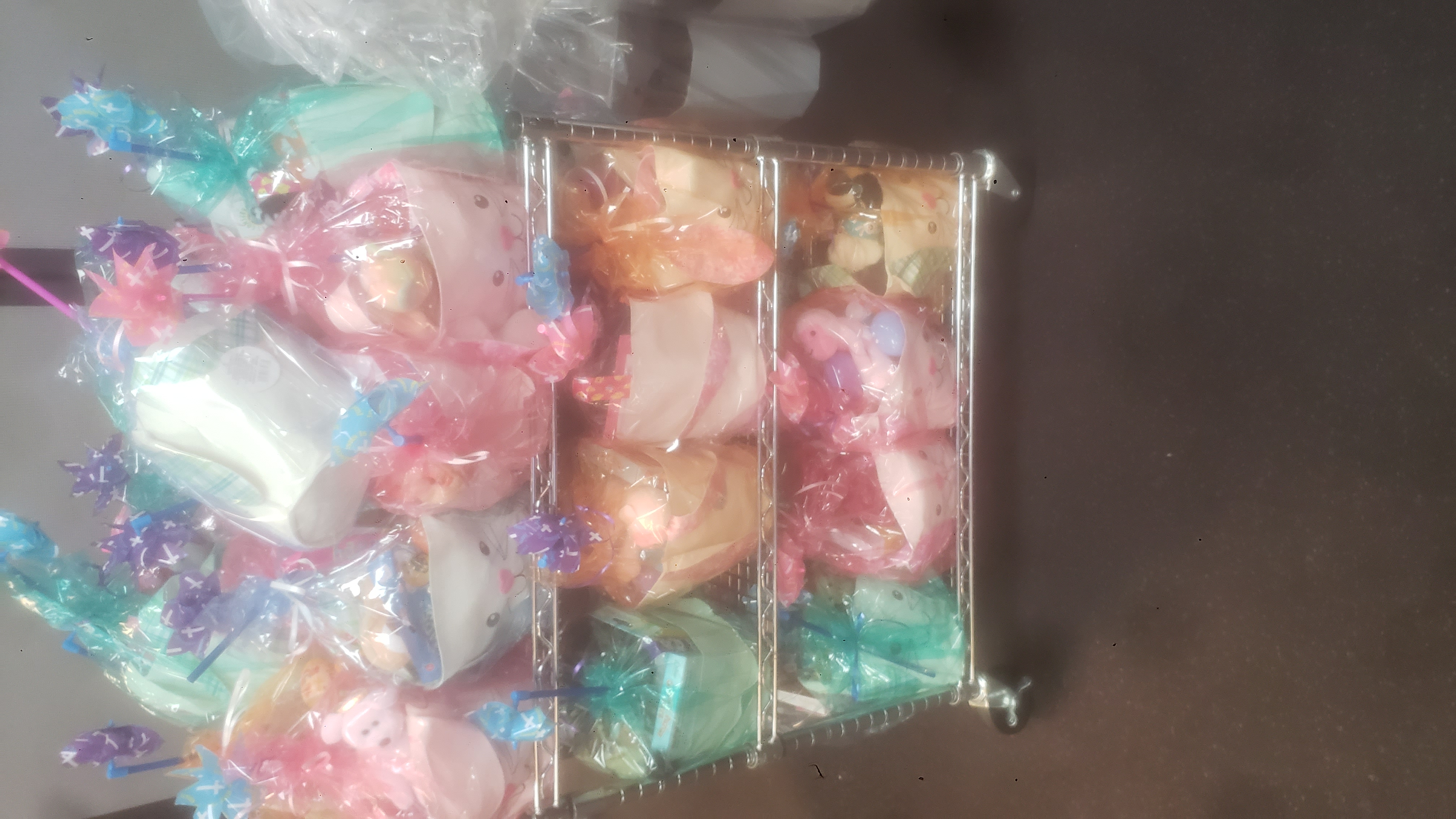 Candies and toys filled rabbit shaped easter baskets in plastic.