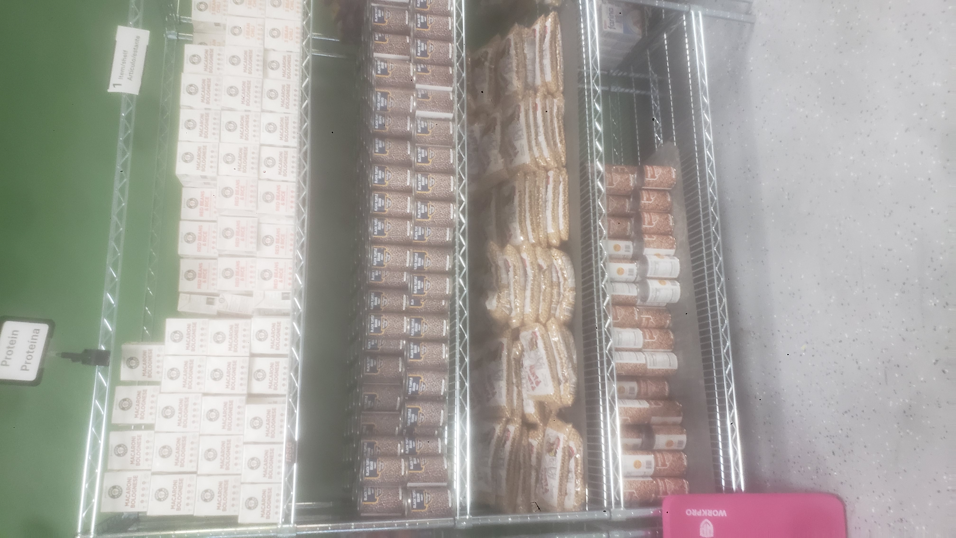 Canned pinto beans, bags of chickpeas, canned black turtle beans, and ready-to-eat meals on a four tier shelf.