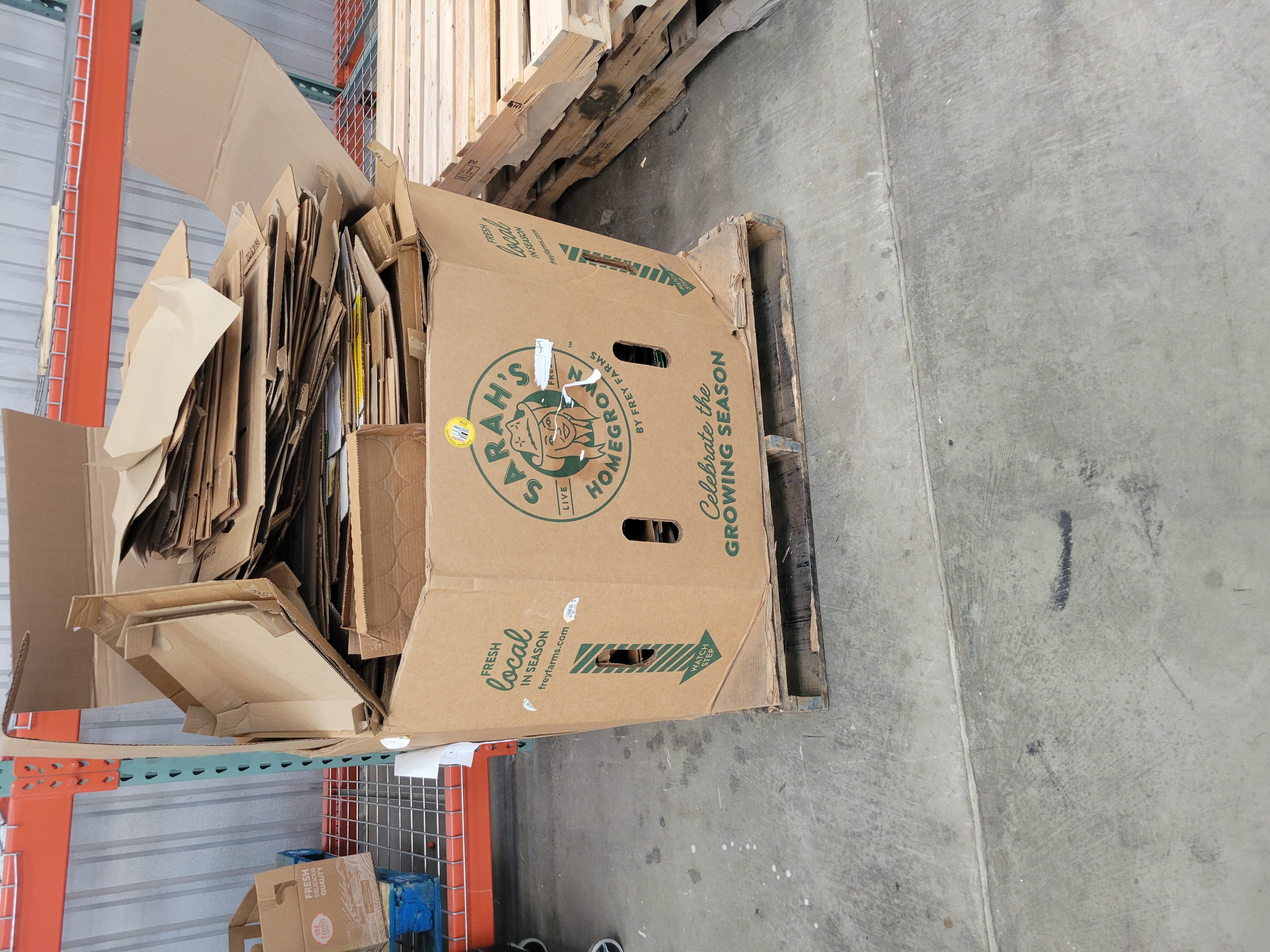 Broken down cardboard in a cardboard container.