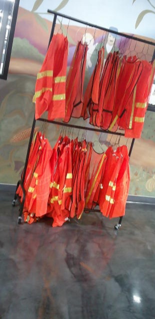 Vests on hangers hanging on racks.