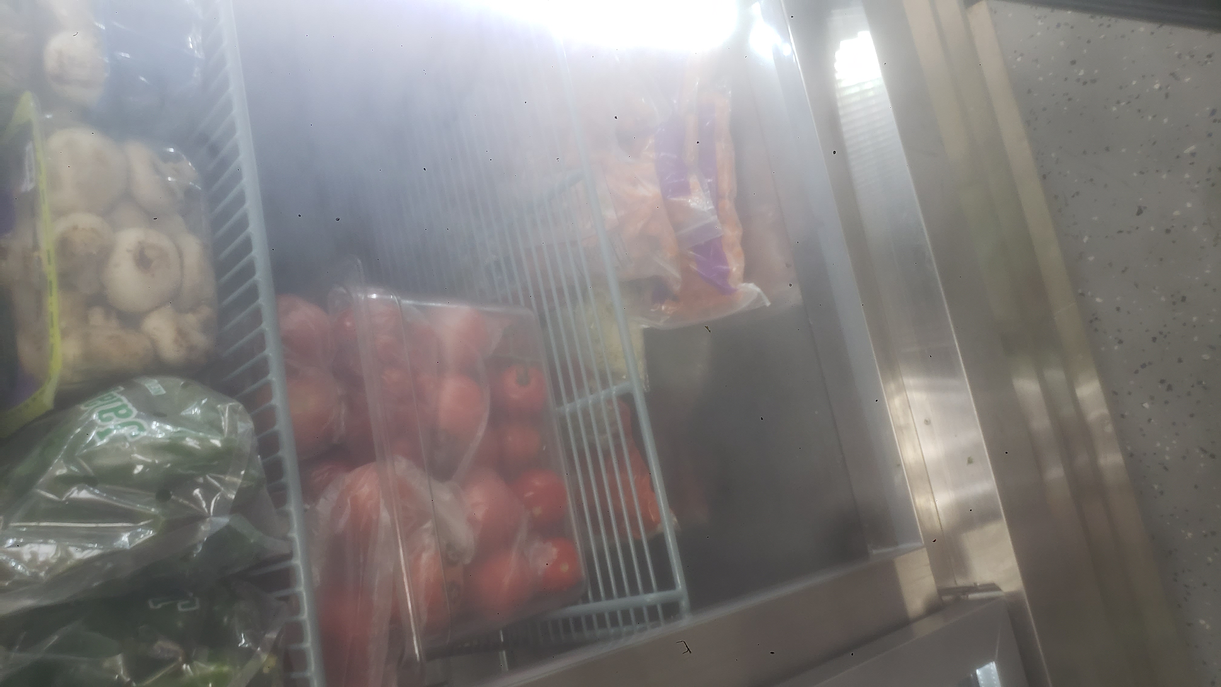 Various produce in a fridge.
