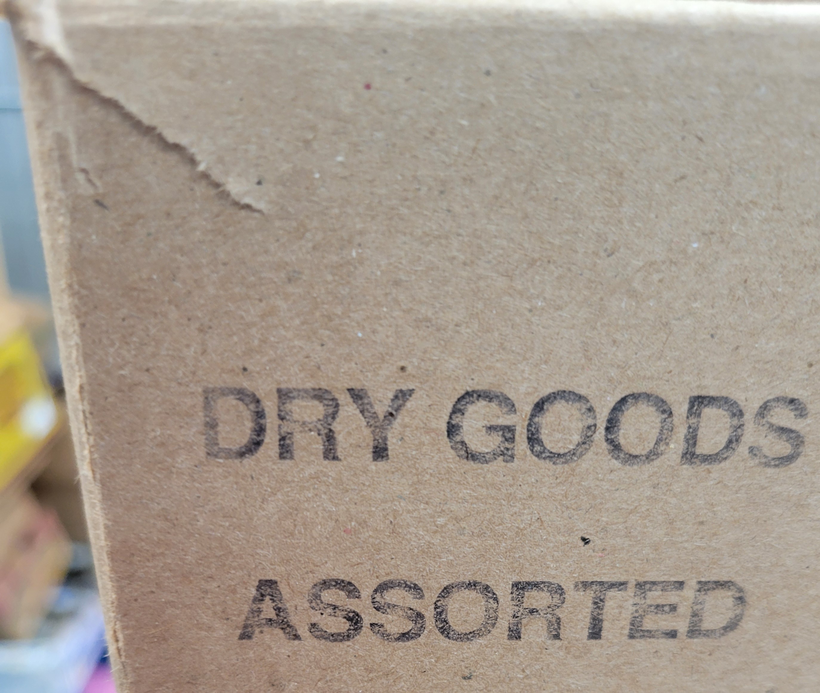 Stamped cardboard box that says dry goods assorted.